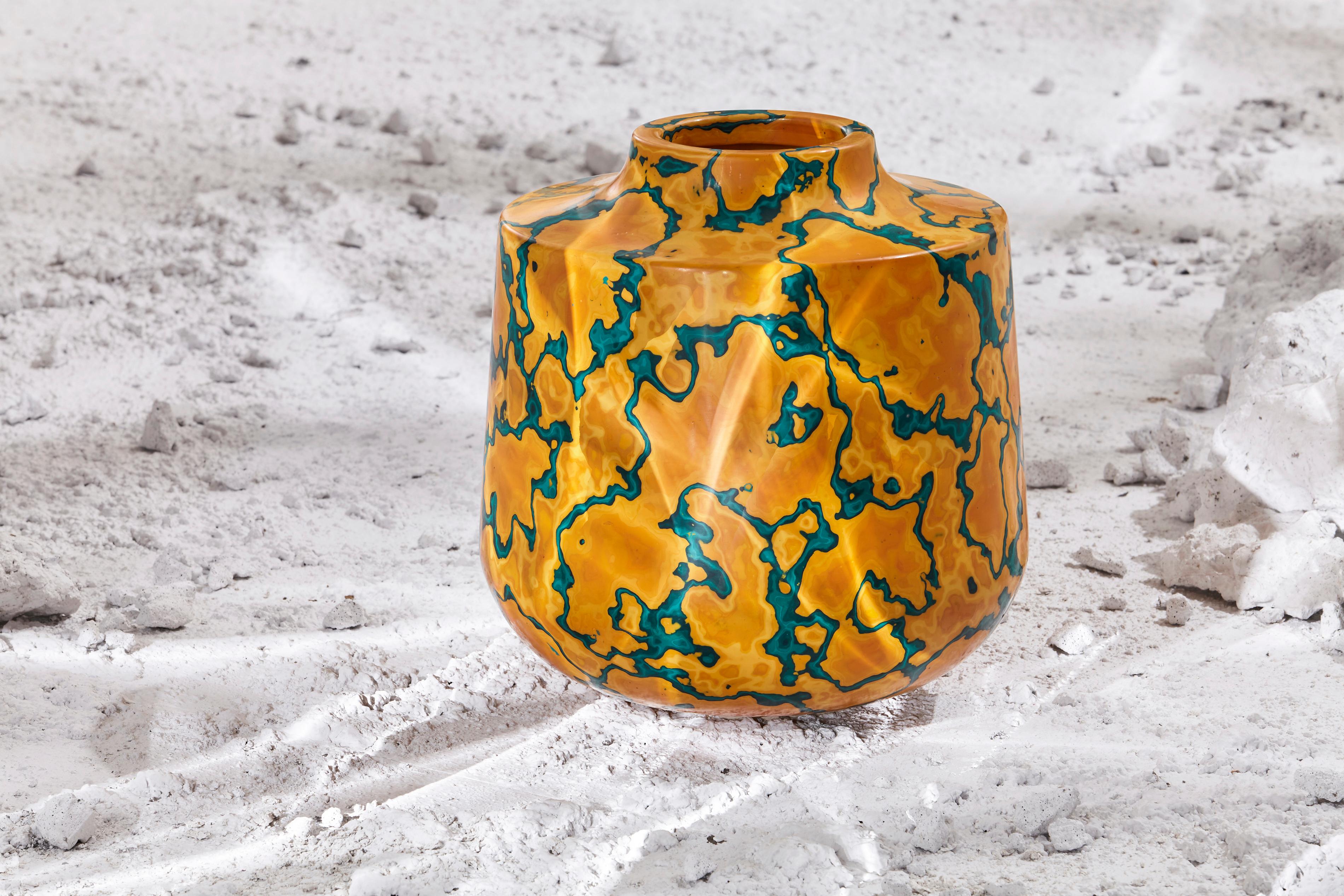 This contemporary vase is created by applying multiple coats of Jesmonite in a three dimensional landscape of textured surfaces. Jesmonite is an environmentally friendly alternative to resin that consists of plaster, pigments and an acrylic binder.