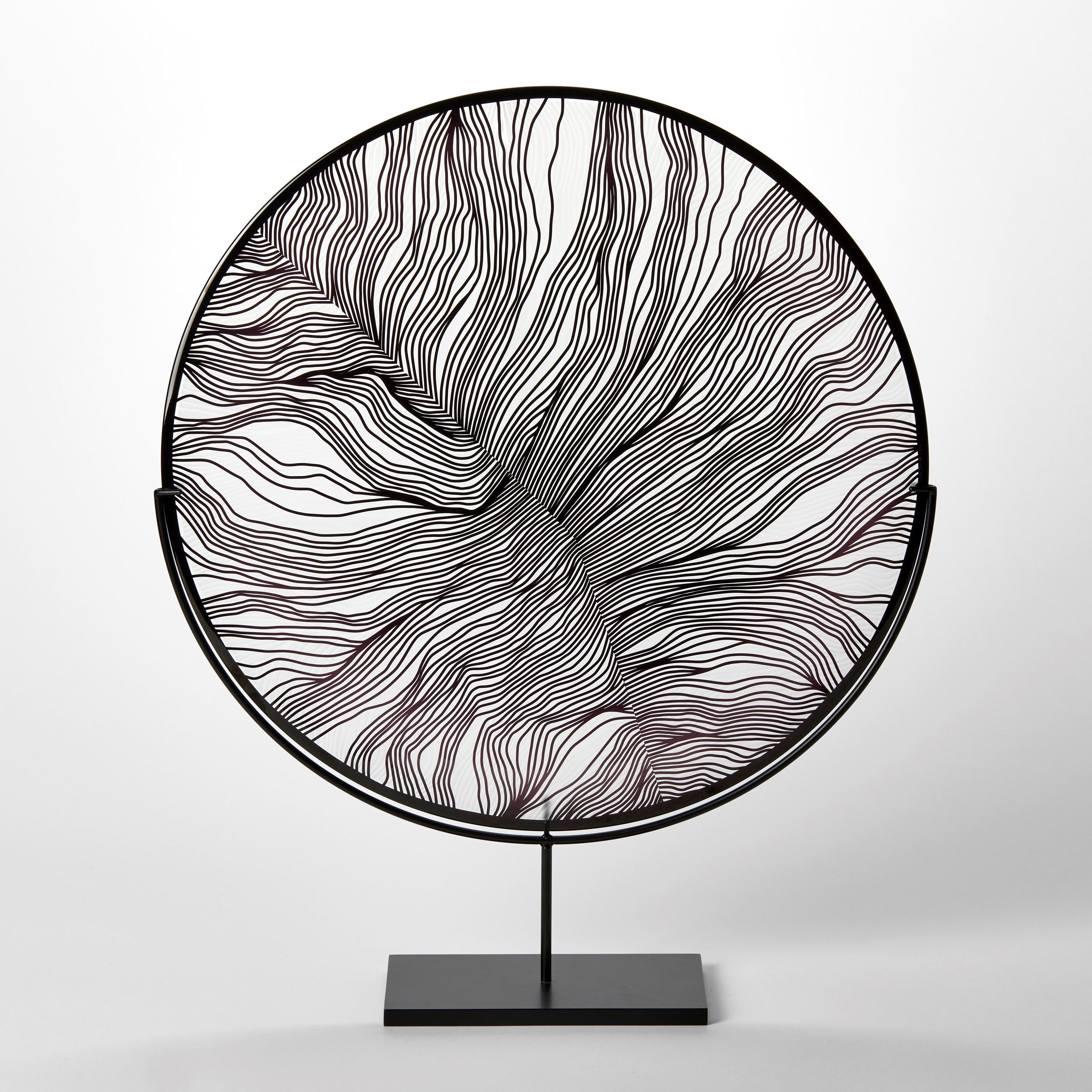 'Solar Storm Monochrome I' is a unique handblown and cut glass artwork by the British artist, Kate Jones of Gillies Jones.

Created with Stephen Gillies, with whom Jones makes many works in collaboration, these exquisite sculptural plates are