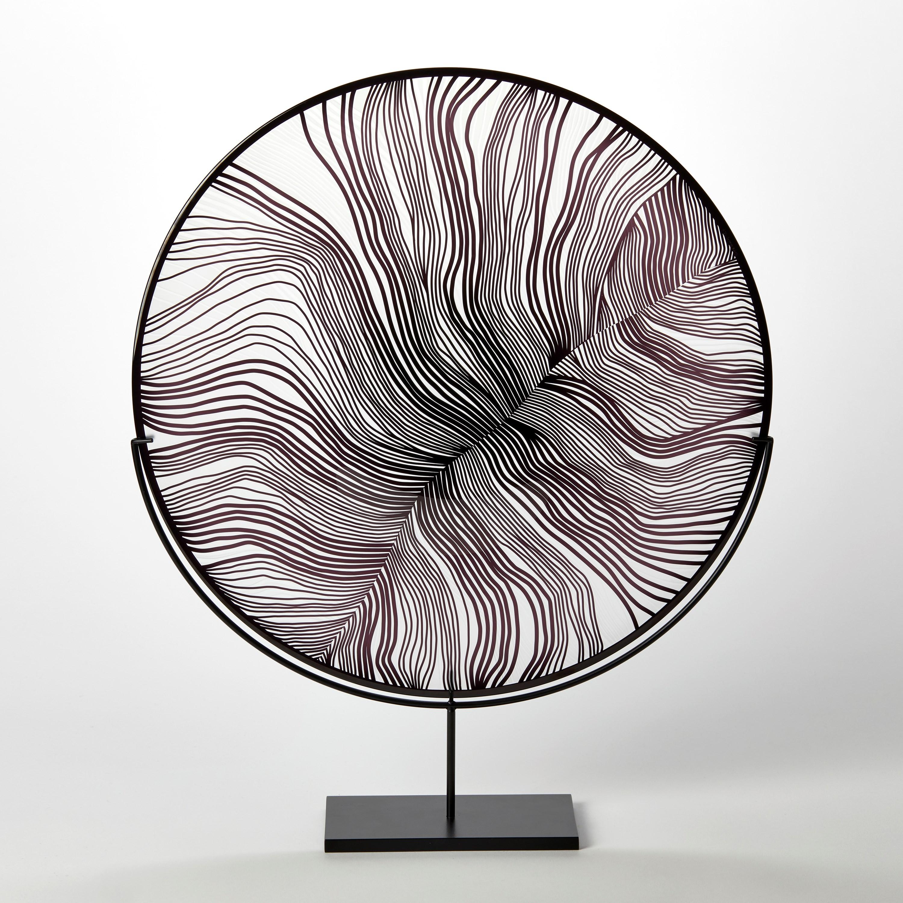 'Solar Storm Monochrome II' is a unique handblown and cut glass artwork by the British artist, Kate Jones of Gillies Jones.

Created with Stephen Gillies, with whom Jones makes many works in collaboration, these exquisite sculptural plates are