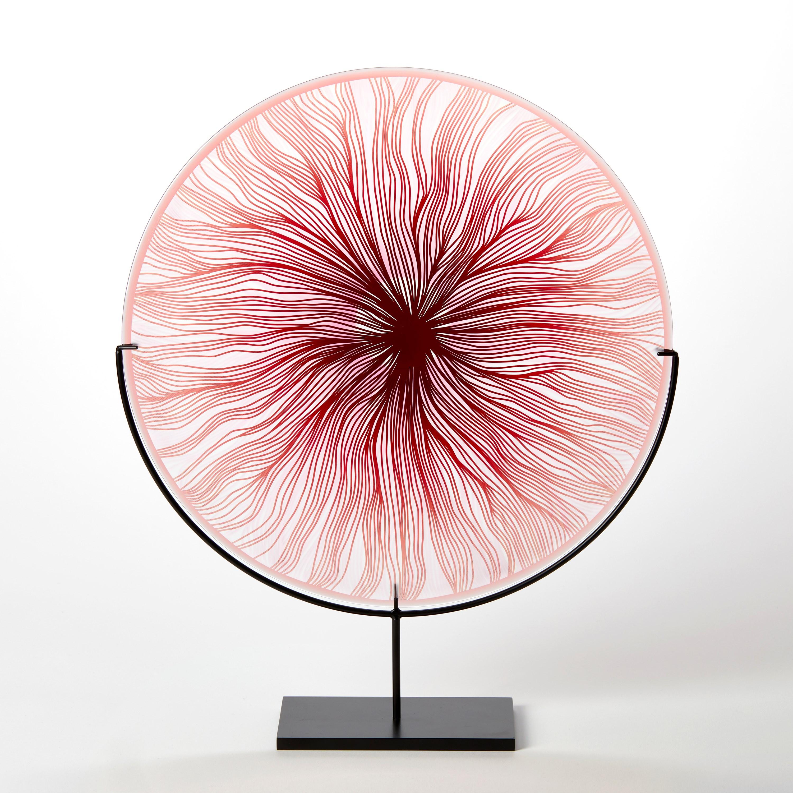 'Solar Storm Ruby Red over Pale Pink' is a unique handblown and cut glass artwork by the British artist, Kate Jones of Gillies Jones.

Created with Stephen Gillies, with whom Jones makes many works in collaboration, these exquisite sculptural plates