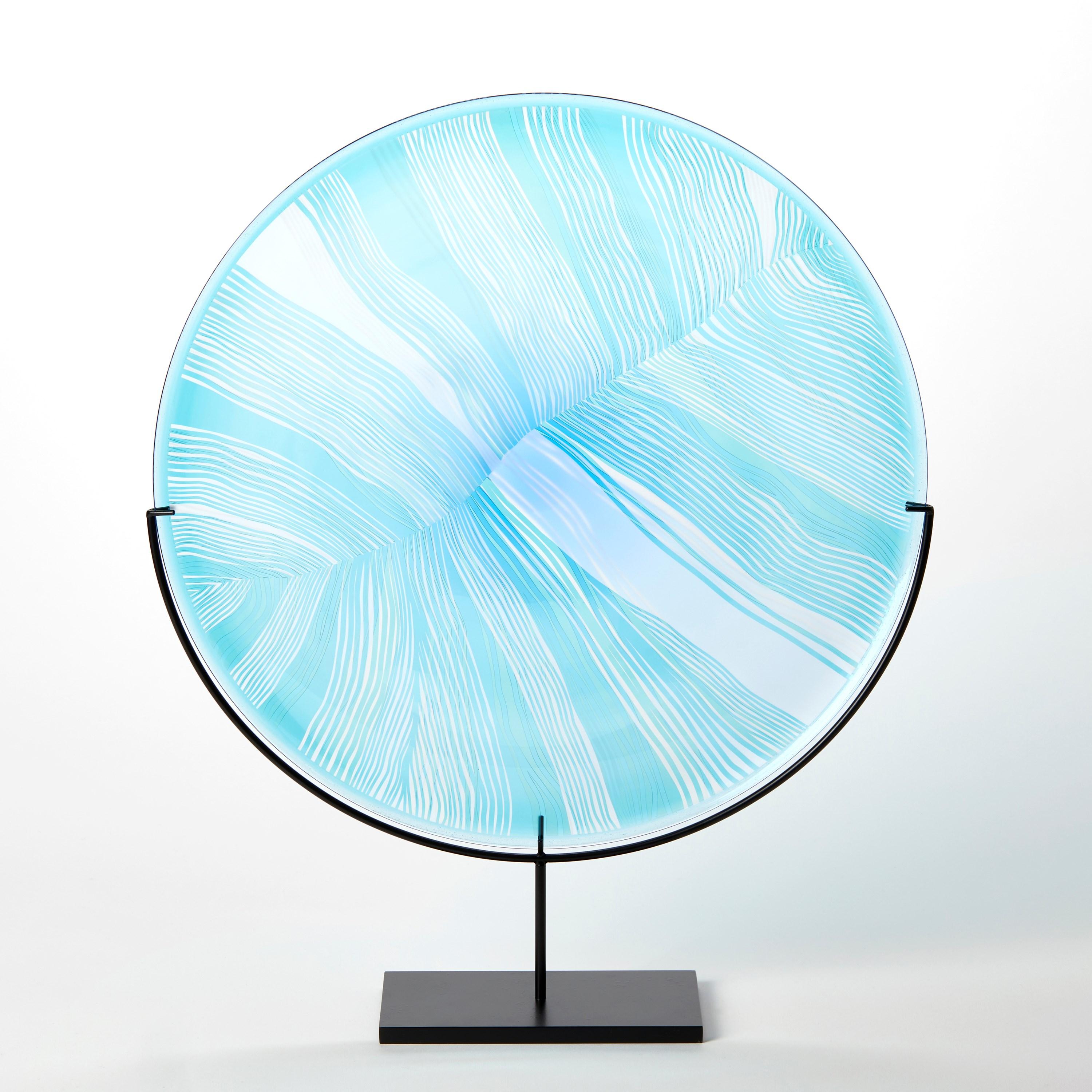 'Solar Storm Sky Blue over Ice Blue I' is a unique handblown and cut glass artwork by the British artist, Kate Jones of Gillies Jones.

In the artist's own words:

“This new body of work references both the evident structure of the landscape and the