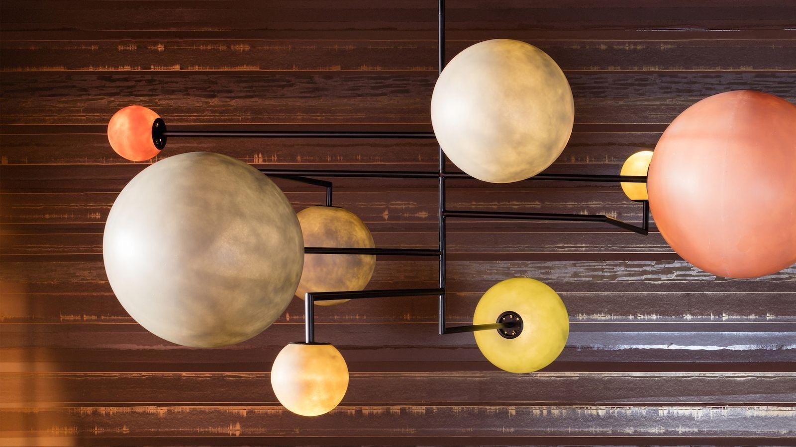 Solar system horizontal chandelier Lambada 061, Dimoremilano lighting, Italy. Resembling a solar system, this ceiling lamp is made in matte black painted metal with handmade spheres of colored fiberglass.

Dimoremilano's Progretto Non Finito