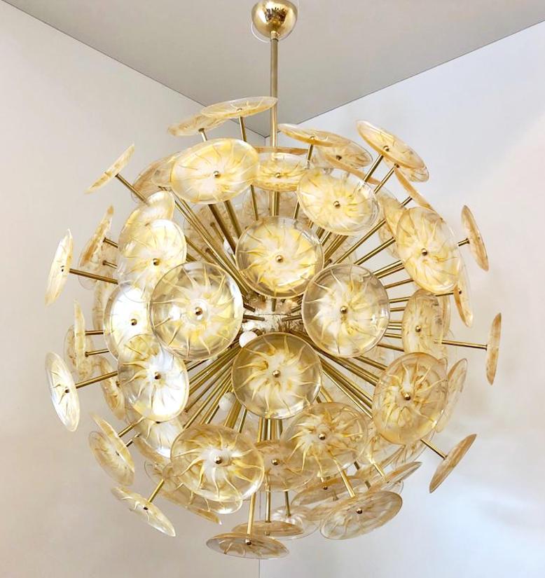 Italian chandelier with round engraved Venetian glasses decorated in gold color, mounted on unlacquered natural brass frame / Exclusively designed by Gianluca Fontana for Fabio Ltd / Made in Italy
18 lights / E12 or E14 type / max 40W each
Measures: