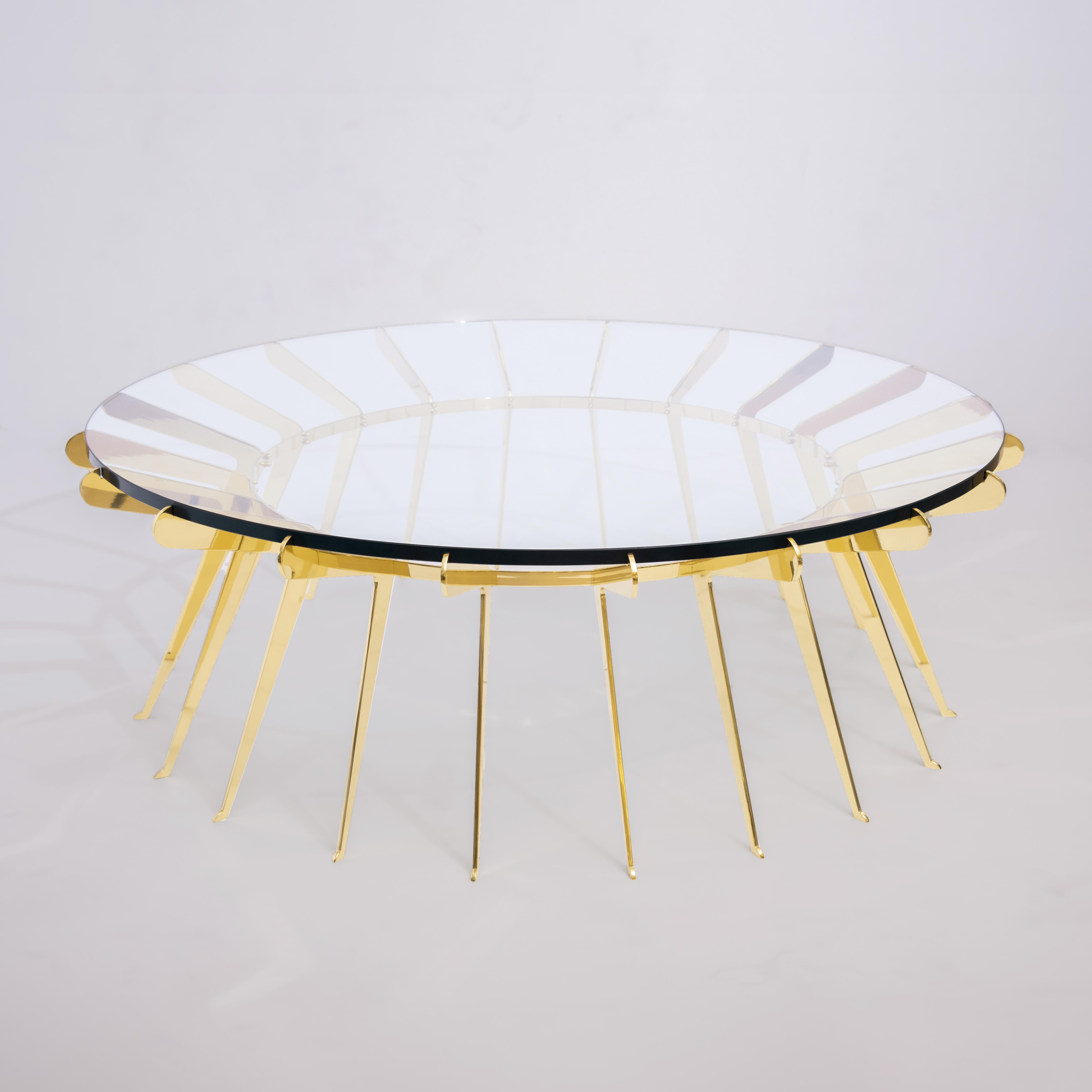 The Solare table by form A plays on the concept of strength in numbers where numerous delicately designed brass legs come together to hold a thick clear glass top. Shown in polished brass with a 51” diameter.

Customization Options: 

Each piece is