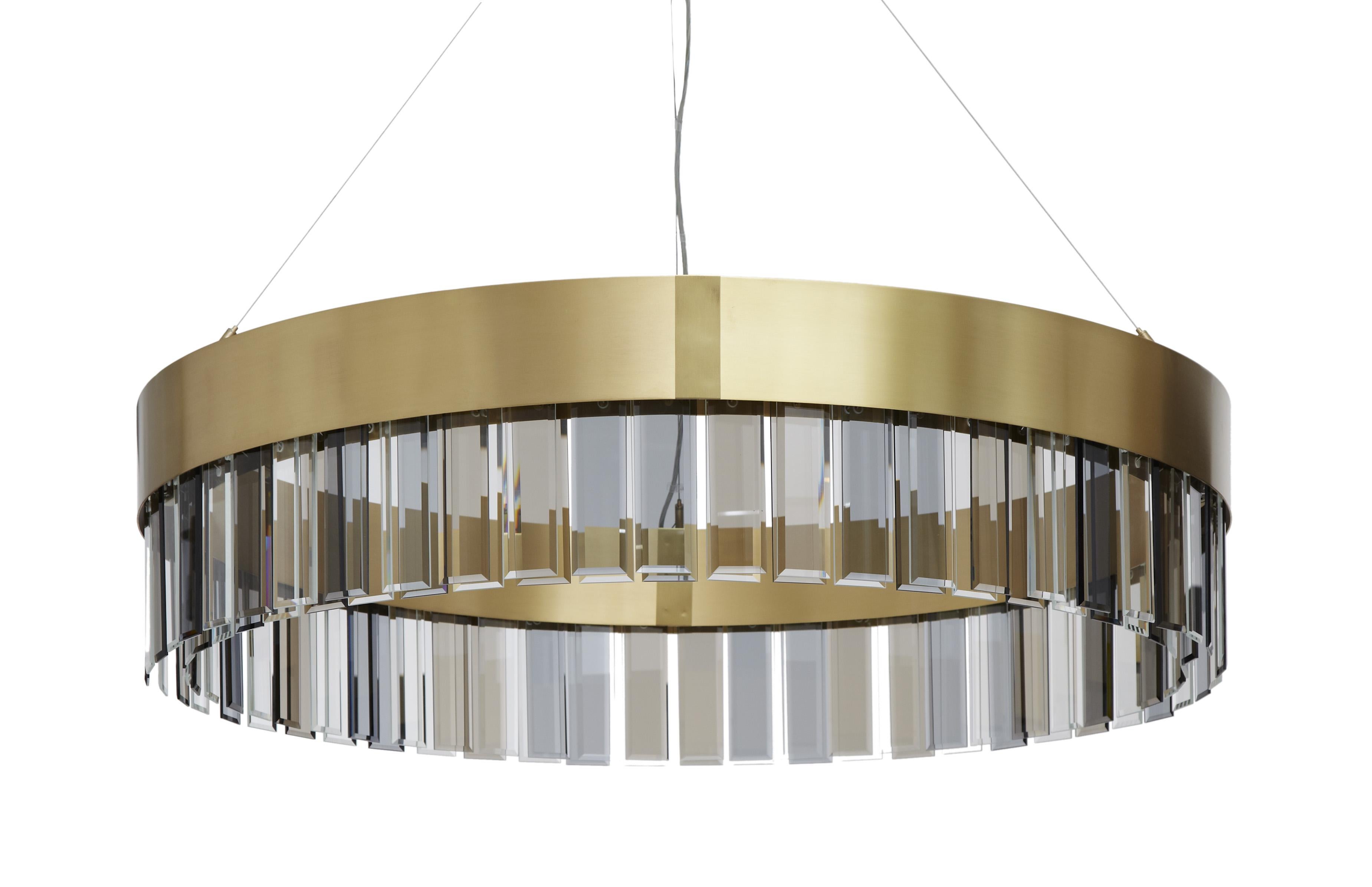 Solaris 1100 pendant by CTO Lighting
Materials: Satin brass with cut glass drops and stainless steel suspension wire/clear flex
Dimensions: H 25 x W 110 cm 

All our lamps can be wired according to each country. If sold to the USA it will be