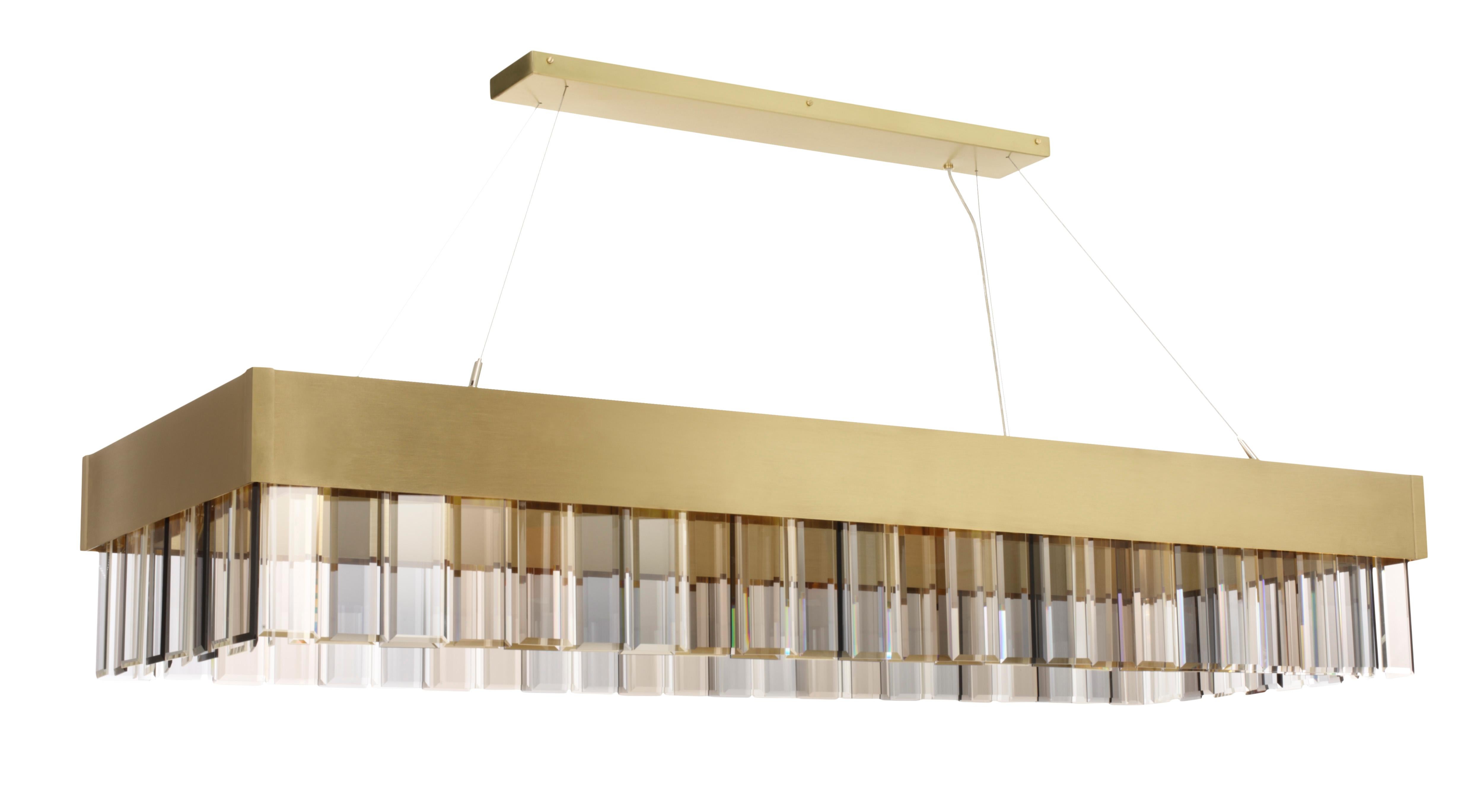Solaris longlight pendant by CTO Lighting
Materials: satin brass with cut glass drops and stainless steel suspension wire/clear flex
Dimensions: H 25 x W 140 cm 

All our lamps can be wired according to each country. If sold to the USA it will