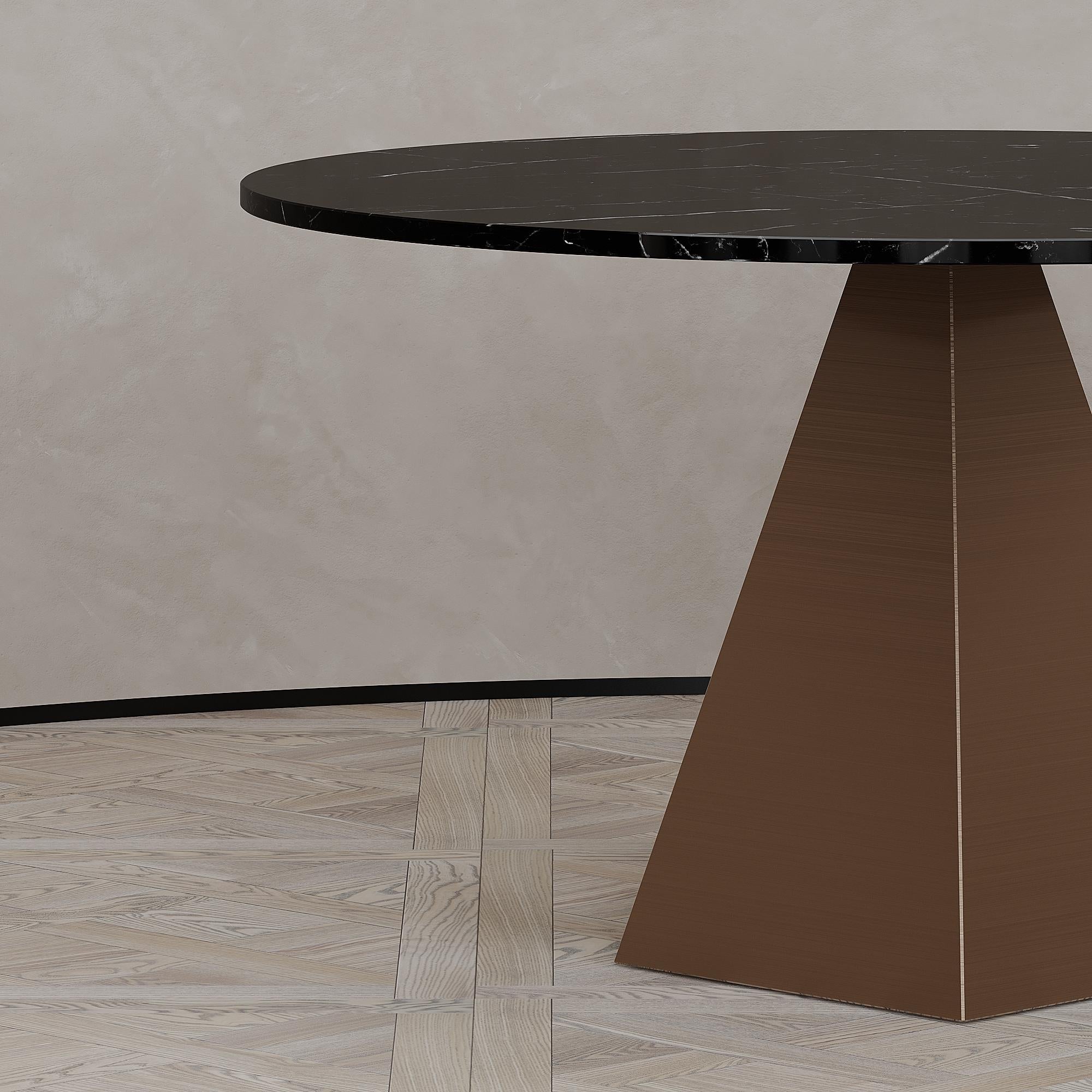 The Solaris dining table is designed by Emél & Browne in the Minimalist and contemporary style and custom made in Italy by skilled artisans.

The Solaris dining table with its glowing copper base emits a healing sunset energy into interior spaces.