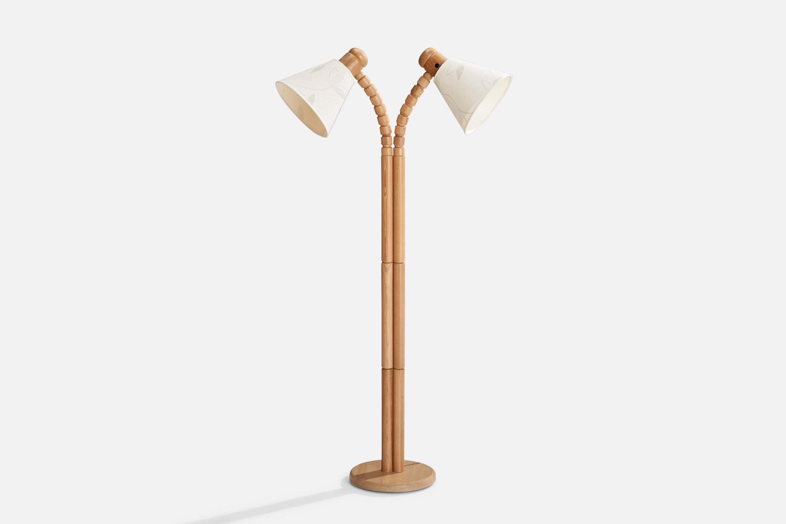 An adjustable two-armed pine and fabric floor lamp designed and produced in Sweden, c. 1970s.

Overall Dimensions (inches):52” H x 25.25” W x 21” D
Stated dimensions include shade.
Bulb Specifications: E-26 Bulb
Number of Sockets: 2
All lighting