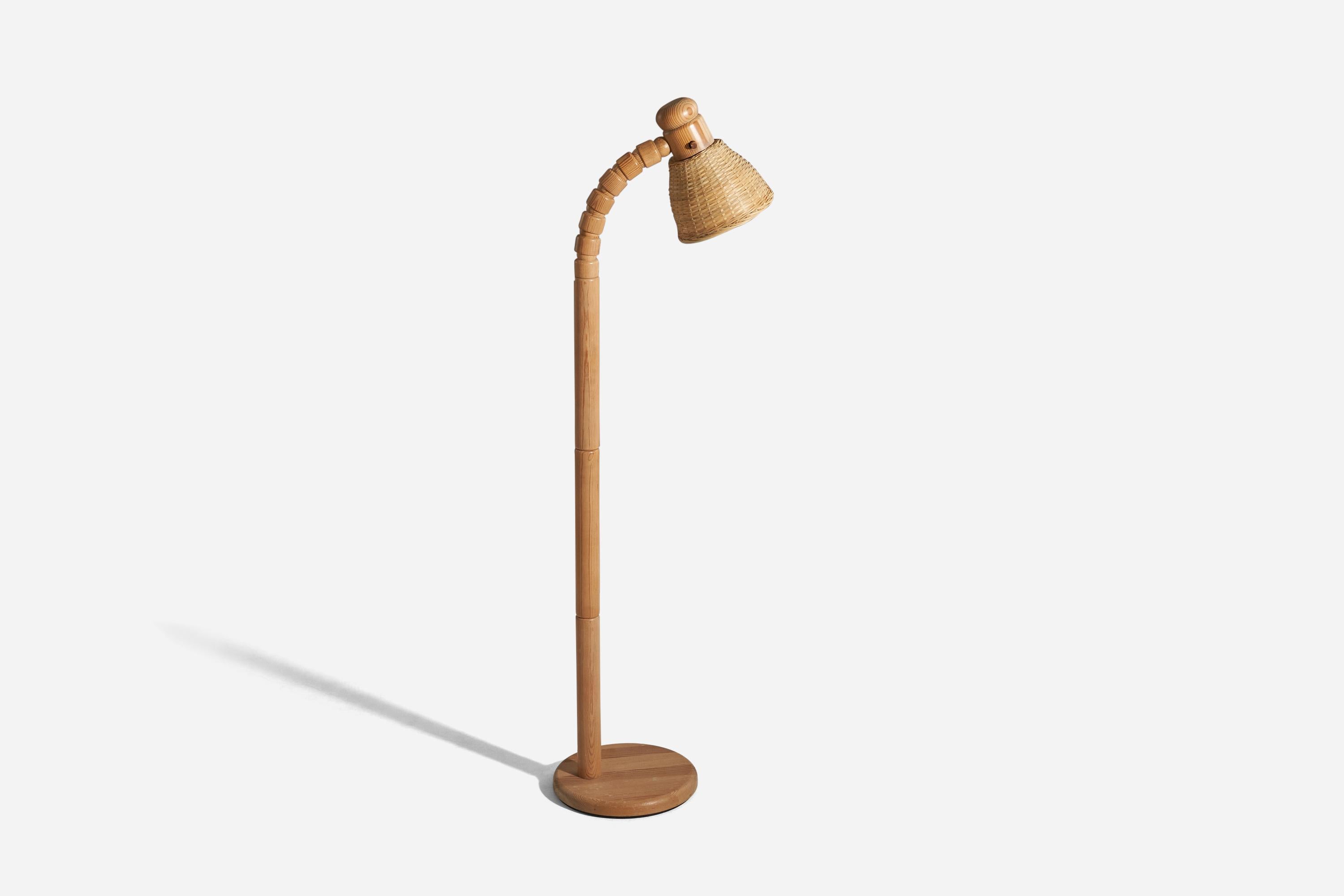 A solid pine and rattan floor lamp designed and produced by Solbackens Svarveri, Sweden, 1970s.

Sold with Lampshade(s). 
Stated dimensions refer to the Floor Lamp with the Shade(s). 
Variable dimensions, measured as illustrated in the first