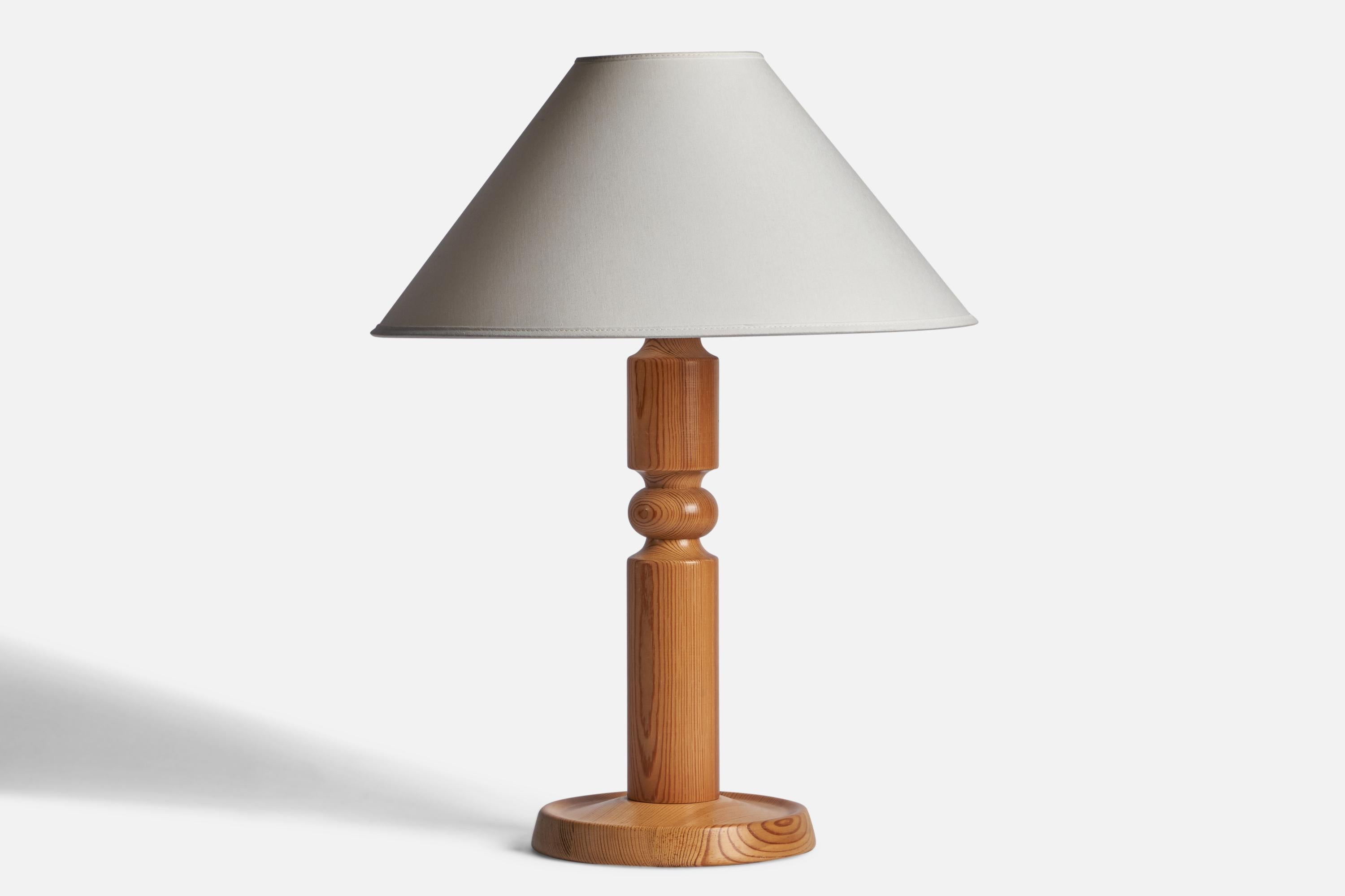 A pine table lamp designed and produced by Solbackens Svarveri, Sweden, 1970s.

Dimensions of Lamp (inches): 16.7” H x 7.5” Diameter
Dimensions of Shade (inches): 4.5” Top Diameter x 16” Bottom Diameter x 7.25” H
Dimensions of Lamp with Shade