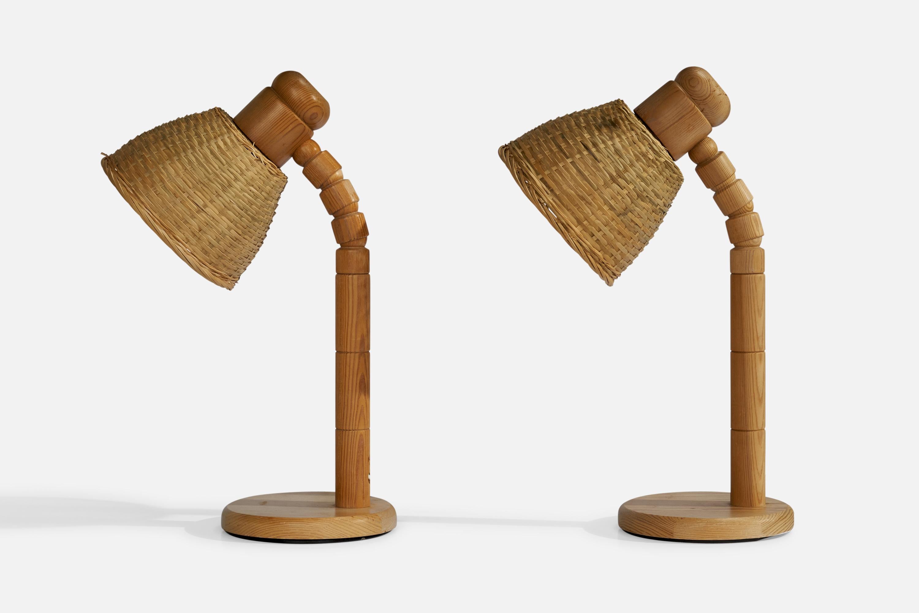A pair of adjustable pine and rattan table lamps designed and produced in Sweden, 1970s.

Overall Dimensions (inches): 18” H x 7” W x 11.5” D
Stated dimensions include shade.
Bulb Specifications: E-26 Bulb
Number of Sockets: 2
All lighting will be