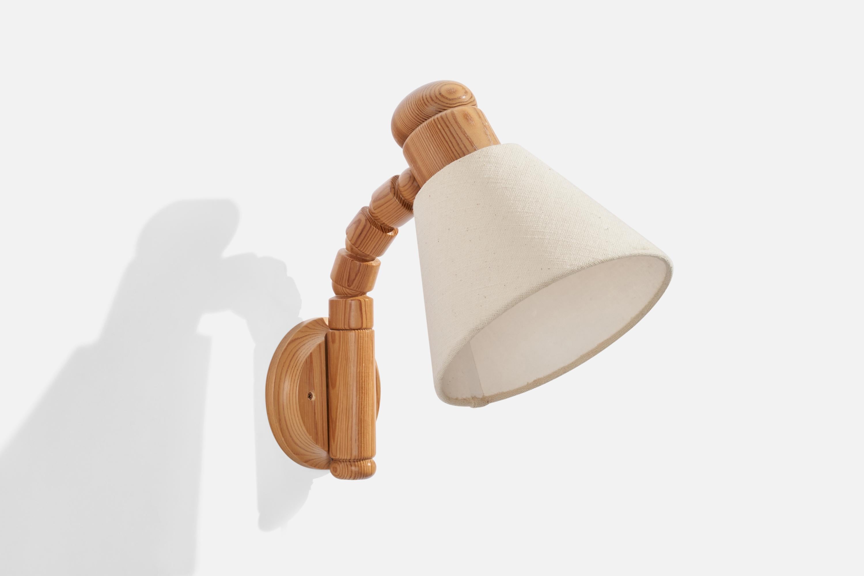 An adjustable pine and white fabric wall light produced by Solbackens Svarveri, Sweden, 1970s.

Dimensions variable 
Overall Dimensions (inches): 16” H x 7.5” W x 8.75” D
Back Plate Dimensions (inches): 4.56” H x 0.85” D
Bulb Specifications: E-26