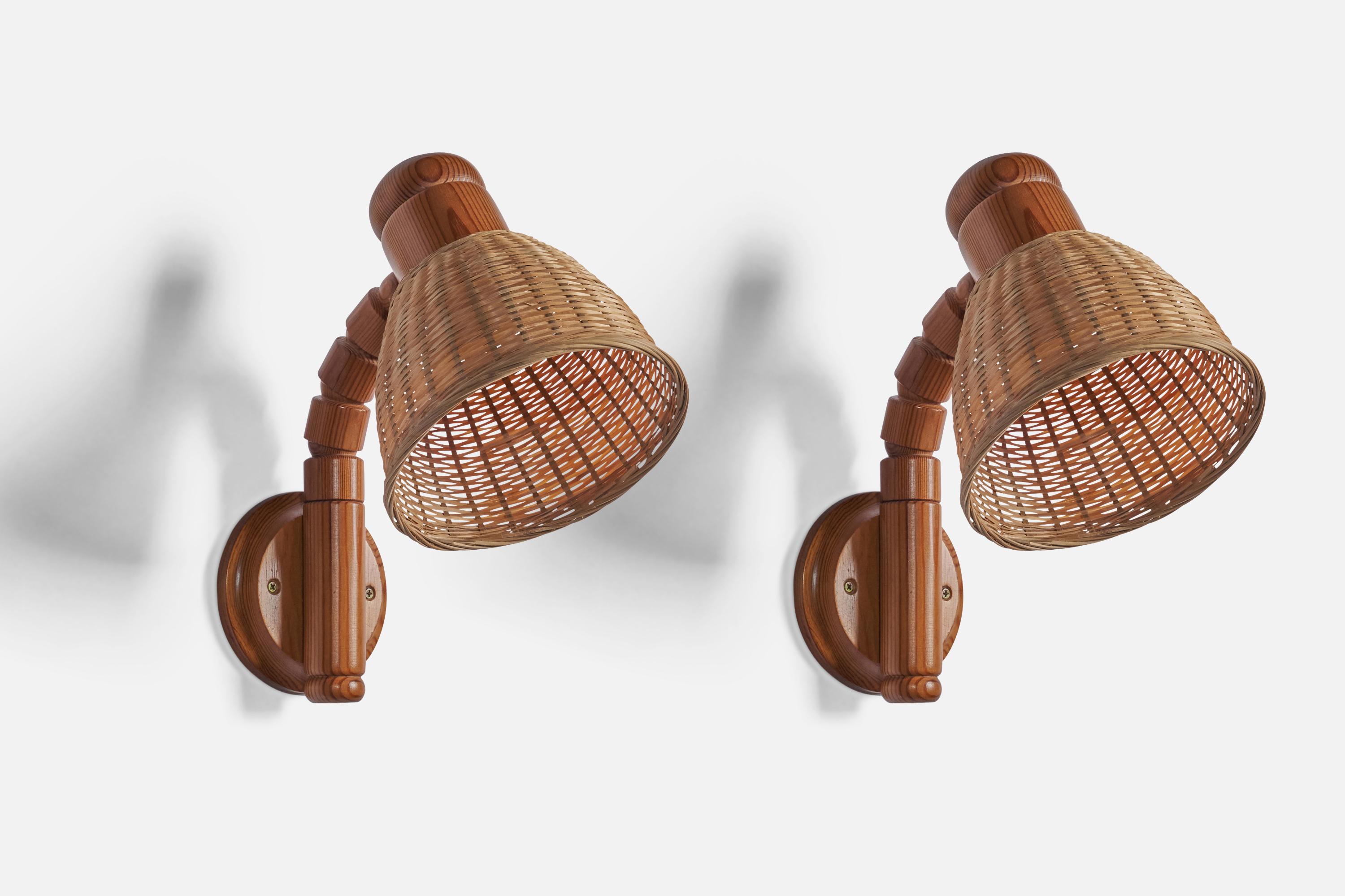 A pair of adjustable pine and rattan wall lights designed and produced by Solbackens Svarveri, Sweden, c. 1970s.

Overall Dimensions (inches): 12” H x 6.6” W x 11.25” D 
Bulb Specifications: E-26
Number of Sockets: 1