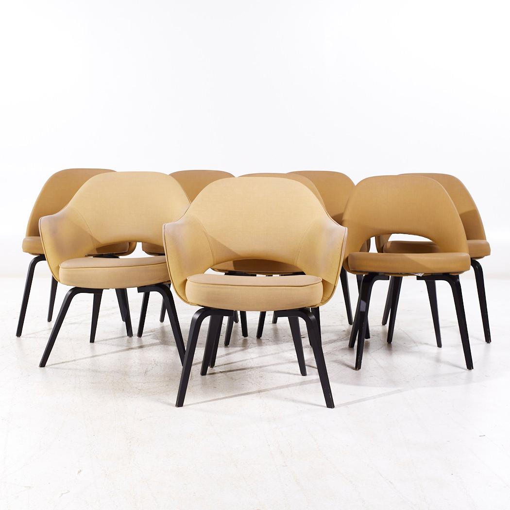 Eero Saarinen for Knoll Mid Century Bentwood Executive Dining Chairs - Set of 8

Each armless chair measures: 22 wide x 21 deep x 31 high, with a seat height of 18.75 inches
Each captains chair measures: 26 wide x 24 deep x 31 high, with a seat
