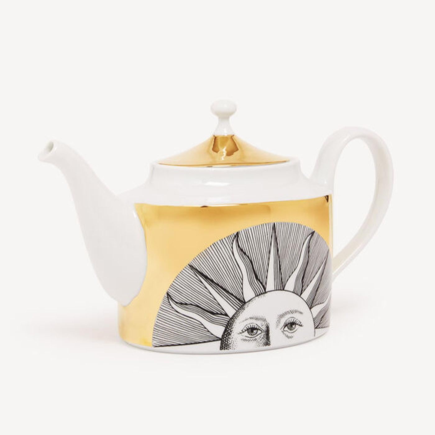 The motif of the sun covers this hand-decorated porcelain teapot with gold accents, transferring Fornasetti's imagery to an object for daily use and thereby transforming it into a collector's item. Any minor discrepancies between similar creations