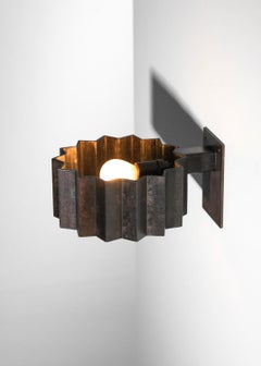 ‘Soleiade’ wall lights by Pierre Donna in hand-patinated steel