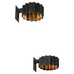 ‘Soleiade’ wall lights by Pierre Donna in hand-patinated steel