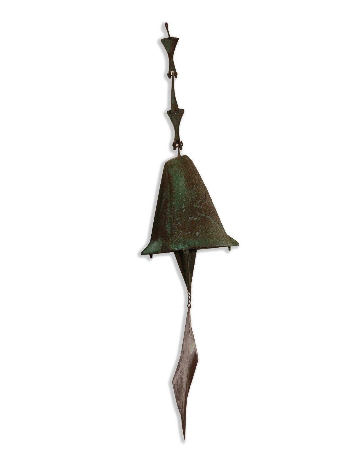 The Soleri Bronze Acrosonti Hanging Bell Sculpture is a striking example of brutalist style within mid-century modern design, characterized by its raw, textured surface and geometric simplicity. This sculpture features a rich patina that adds depth