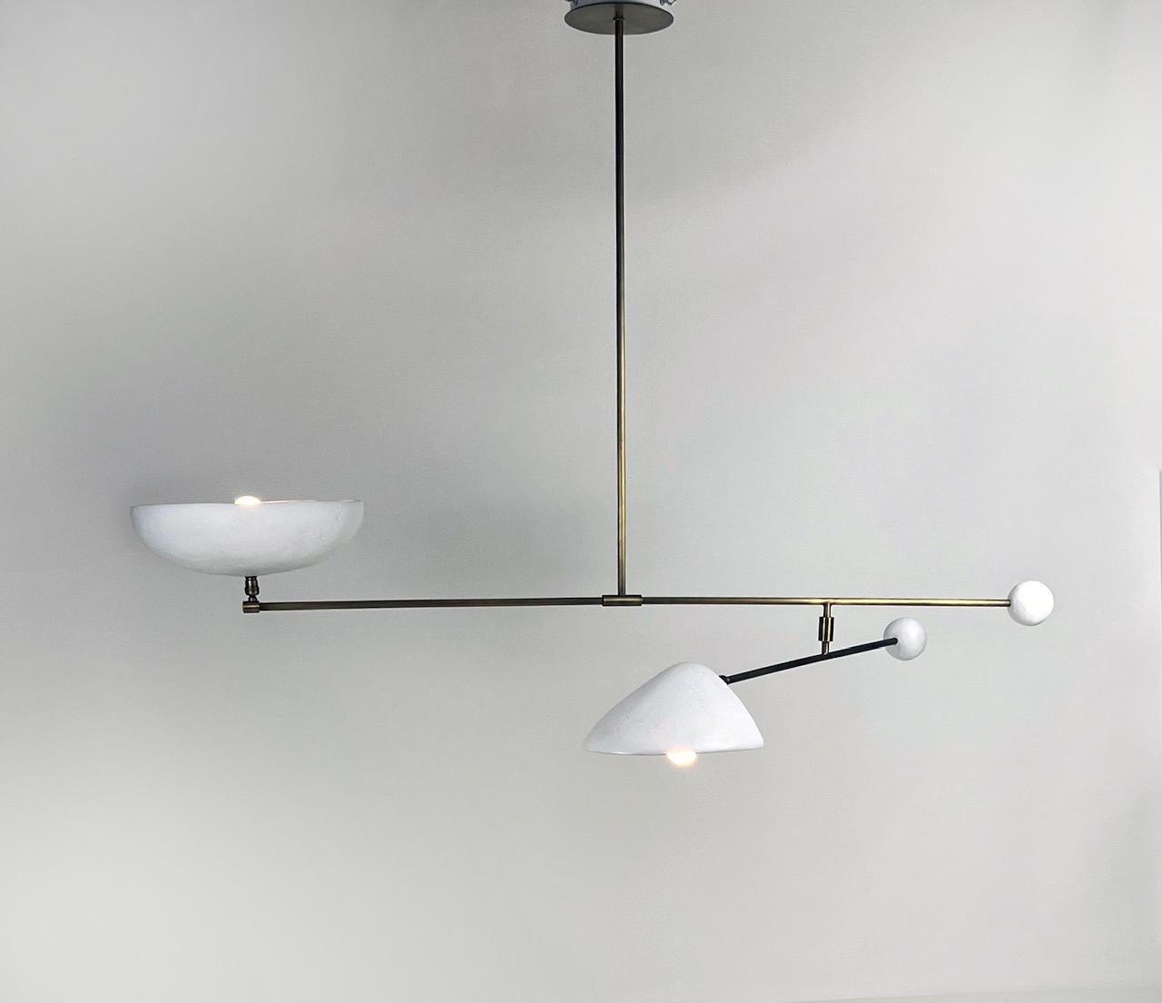 
The Solferino Chandelier, a blend of plaster of Paris and aged brass, is a testament to French elegance and design sophistication. Its articulated structure allows for both upward and downward lighting which can be adjusted to direct the downlight