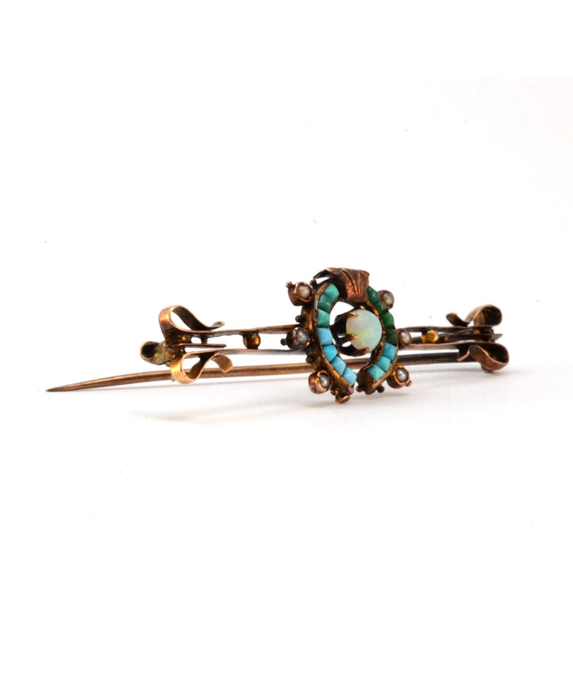 Solid 10K Victorian Pin with Genuine Opal & Turquoise in Excellent Condition! This Victorian pin has 7 opals, approximately .26cttw, and 14 turquoise stones, approximately .39cttw. This pin weighs about 3.2 grams, and is about 2 inches x .5 inches.