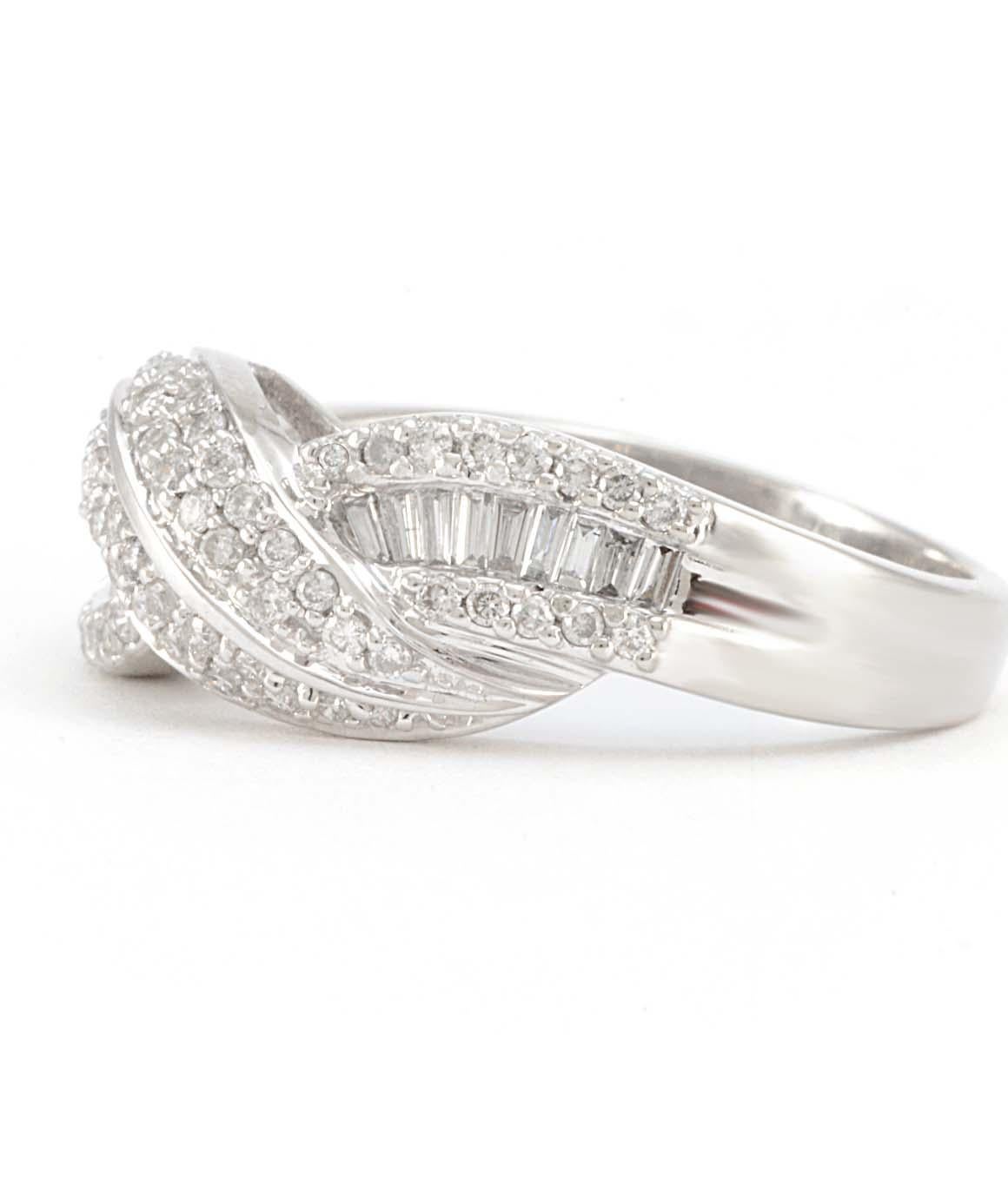 Excellent condition. This twisted band in 14k white gold features 60 genuine round diamonds and 18 genuine baguette diamonds. The ring is a size 7.25 and weighs 4.2 grams.