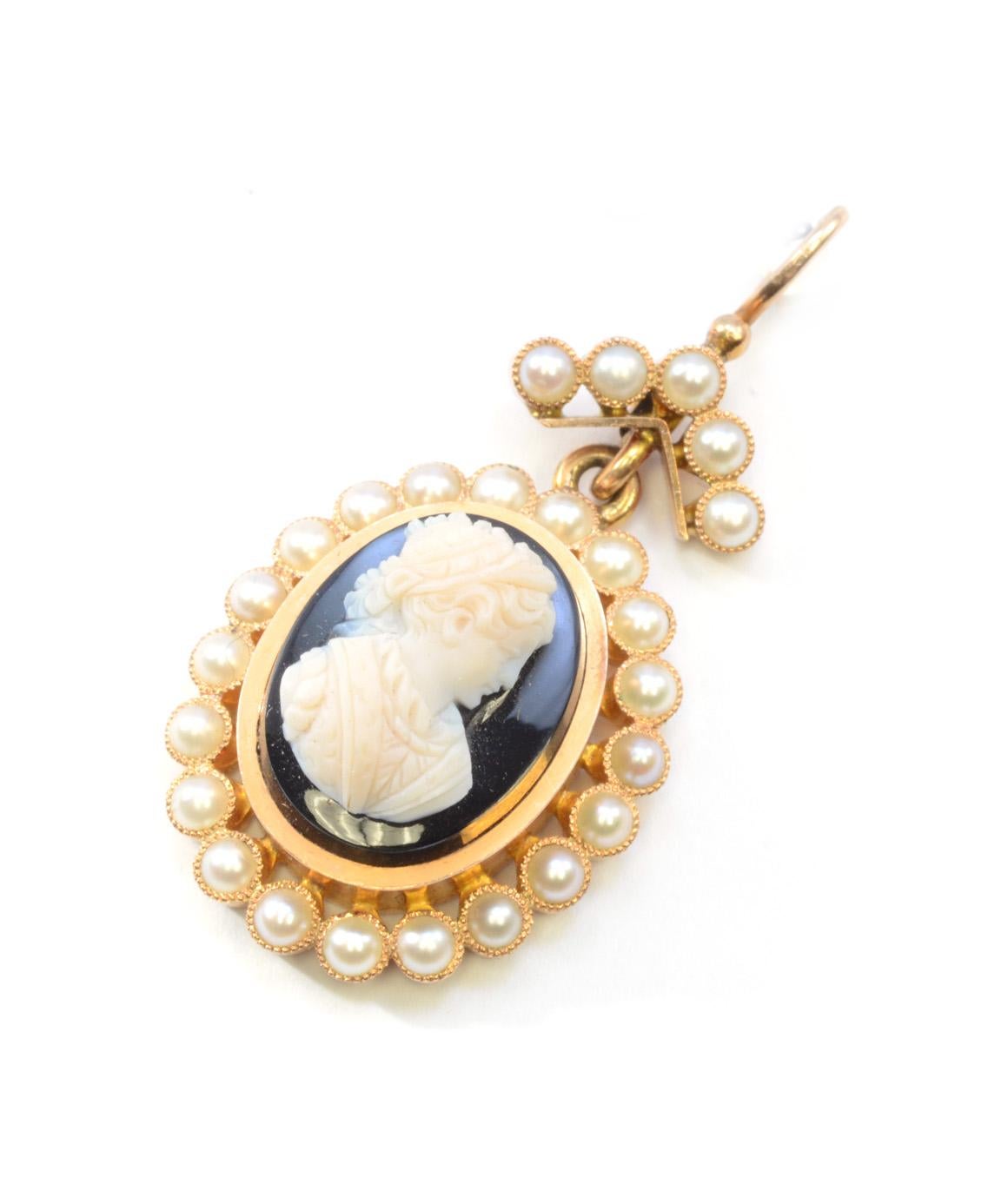 Solid 14K Yellow Gold Antique Onyx & Pearl Cameo Pendant 5.8g 
Excellent condition! This solid 14k yellow gold antique pendant features an oval black onyx measuring 15.06mm X 11.57mm approximately. There are 25 pearls that measure approximately