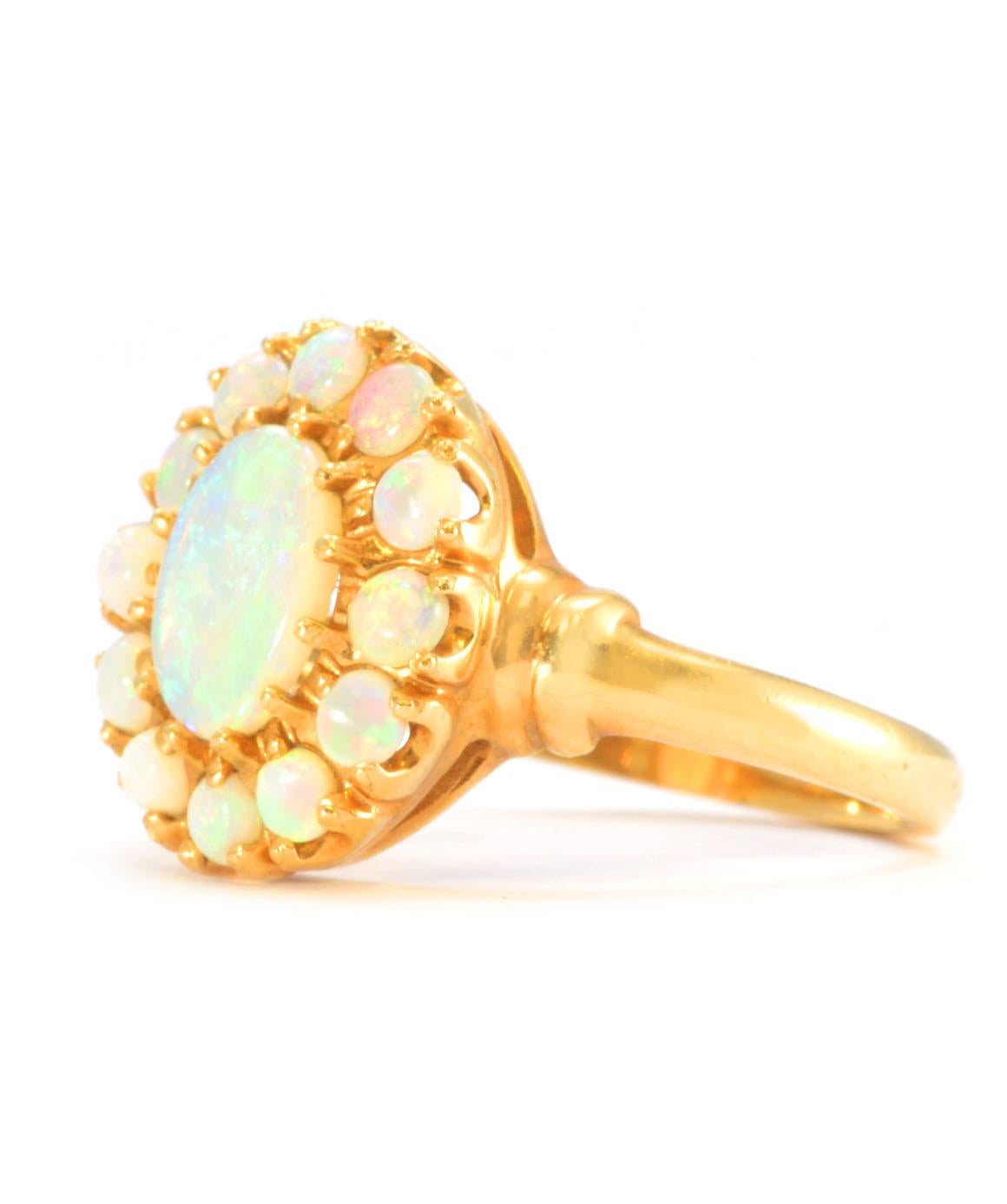 Solid 14K Yellow Gold Genuine Opal Halo Ring 3.2g
Excellent condition. This solid 14K yellow gold ring features a center oval opal stone that measures approximately 8.13mm X 6.20mm. It is surrounded 12 round opal stones that measure approximately