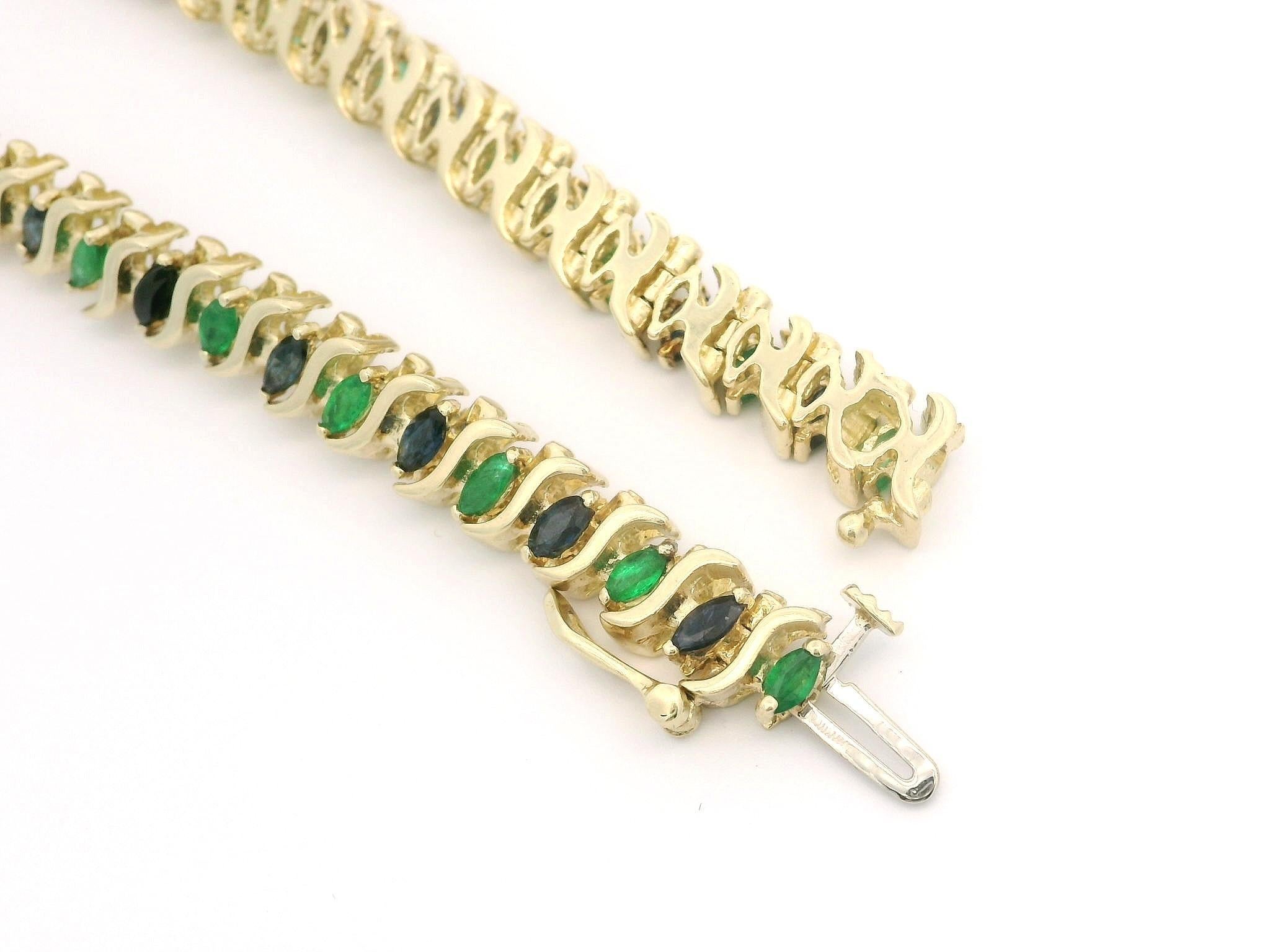 --Stone(s):--
(22) Natural Genuine Sapphires - Marquise Cut - Prong Set - Blue Color
(21) Natural Genuine Emeralds - Marquise Cut - Prong Set - Green Color
Total Carat Weight: 3.0 (approx.)

Material: Solid 14k Yellow Gold
Material Weight: 18.66
