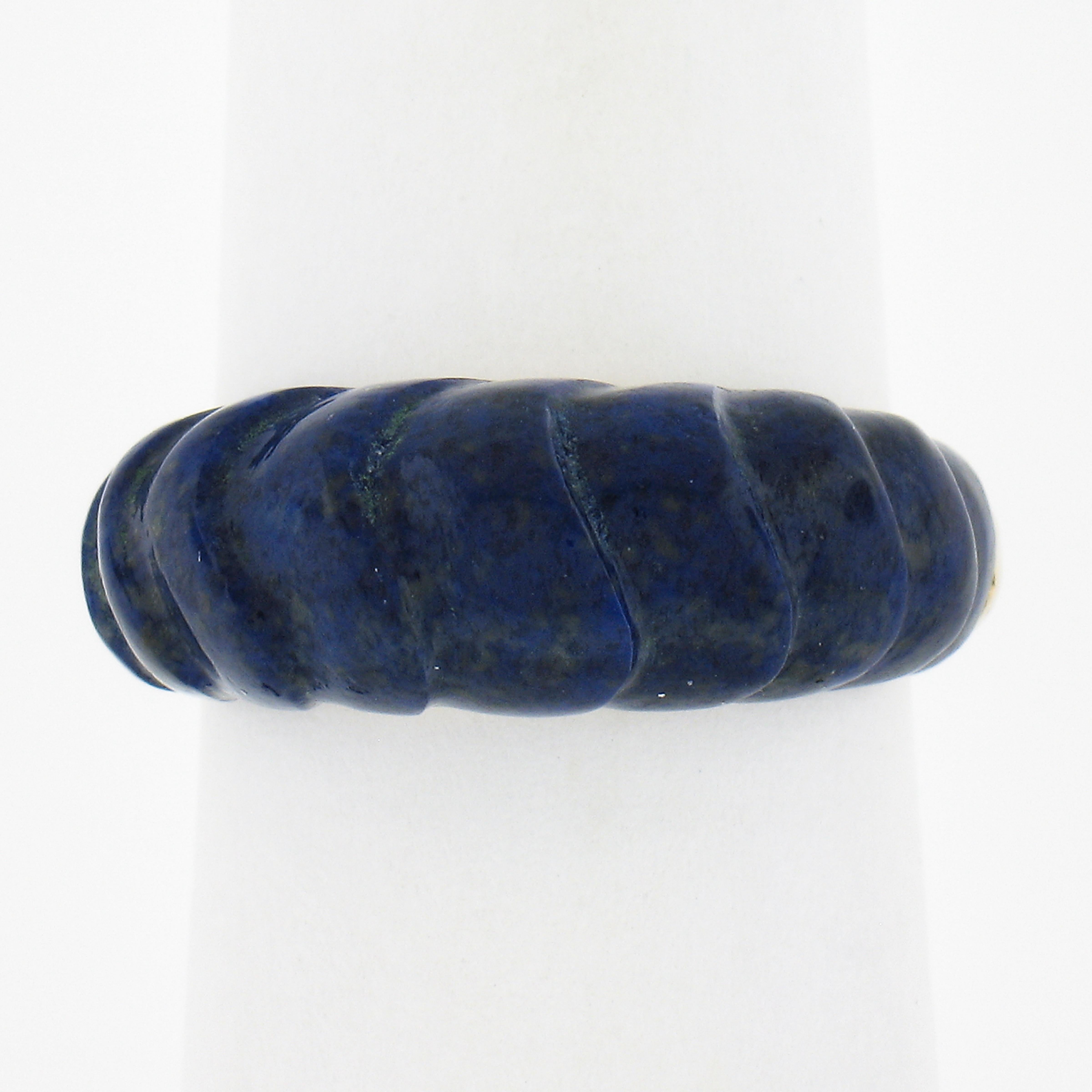 --Stone(s):--
(1) Natural Genuine Lapis - Carved Custom Cut - Inlaid Set - Deep Blue Color

Material: Solid 14k Yellow Gold 
Weight: 5.80 Grams
Ring Size: 5.5 (Fitted on a finger. We can NOT custom size this ring)
Ring Width: 7.7mm (0.30
