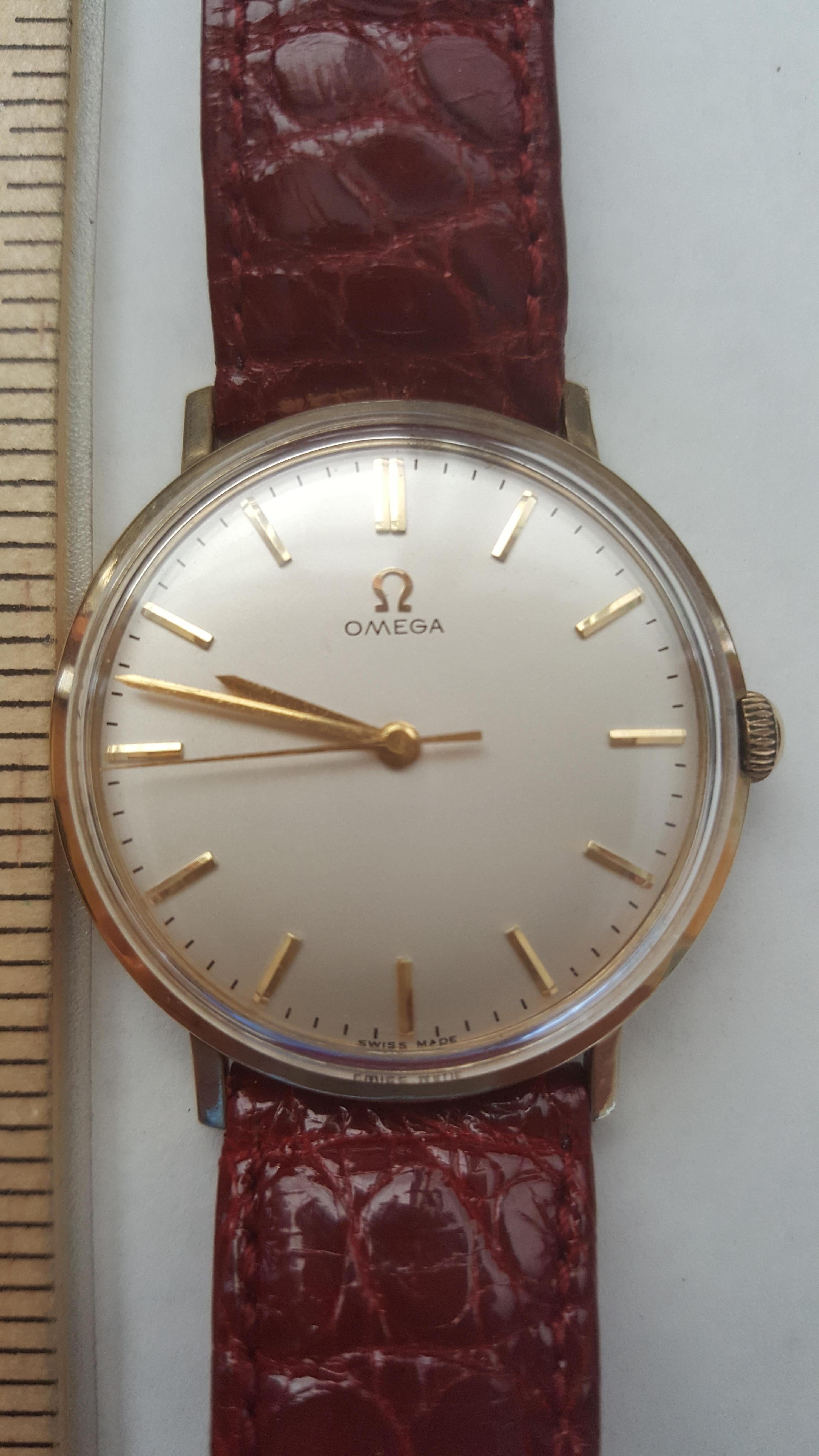 Vintage 14k yellow gold solid Omega watch from approximately 1950's in excellent condition, automatic, with a maroon leather band. This watch was most likely given to a fire fighter for his service and the back is engraved with NYFD 2044 E.16.
 Full