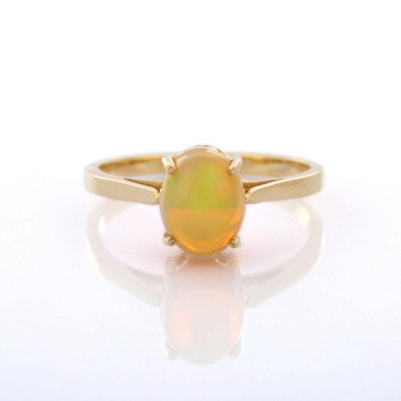 Solitaire Opal Ring in 14K Gold featuring natural opal of 1.26 carats. The gorgeous handcrafted ring goes with every style, every occasion or any outfit. To enhance your look and convey your emotions, stack your rings.
Opal helps to find love, good