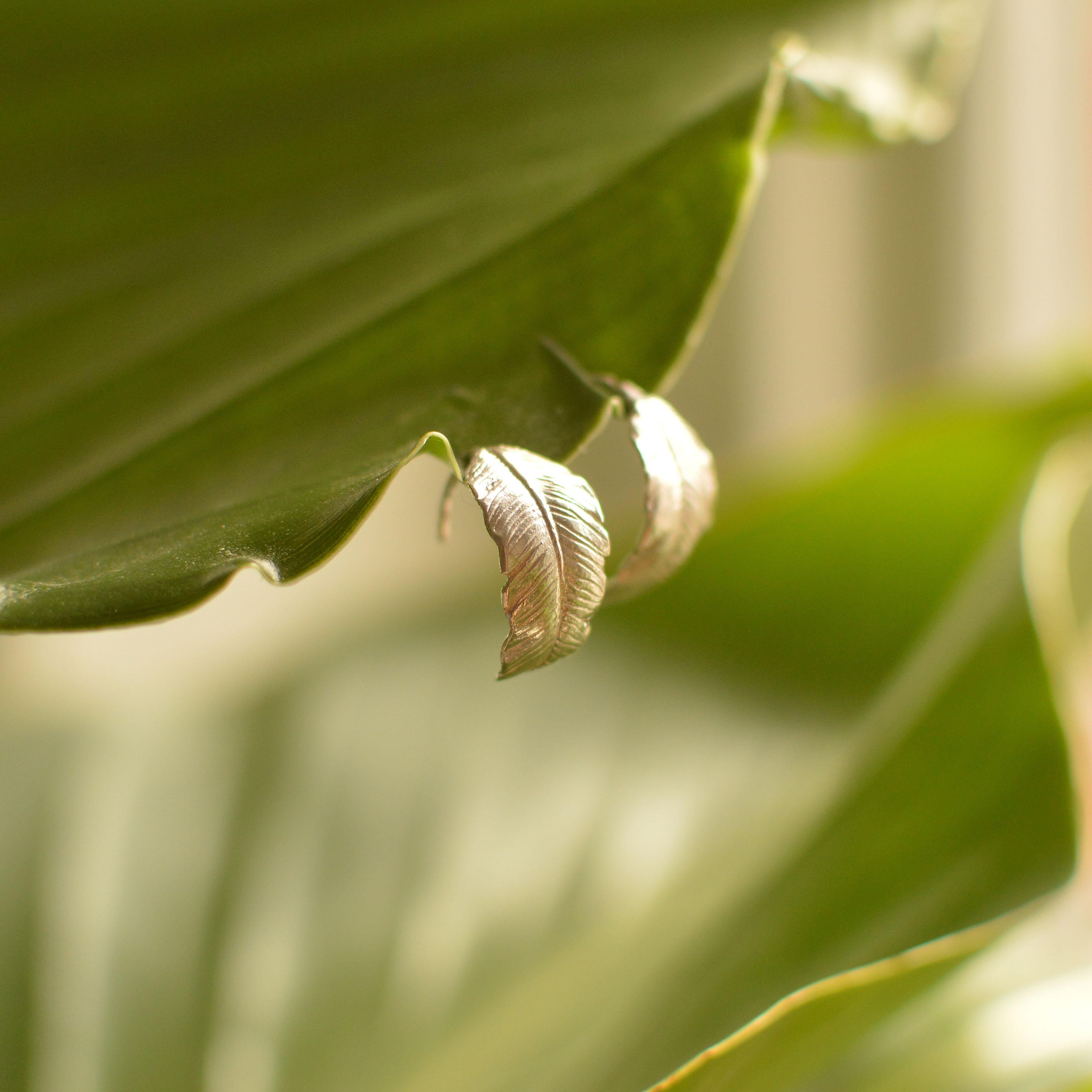 These curling banana leaves form a half-hoop shaped earring are cast in solid 18 Carat gold and finished by hand, and created from Lucy's original hand-sculpted design. 

These butterfly earrings are made in London, United Kingdom using recycled or