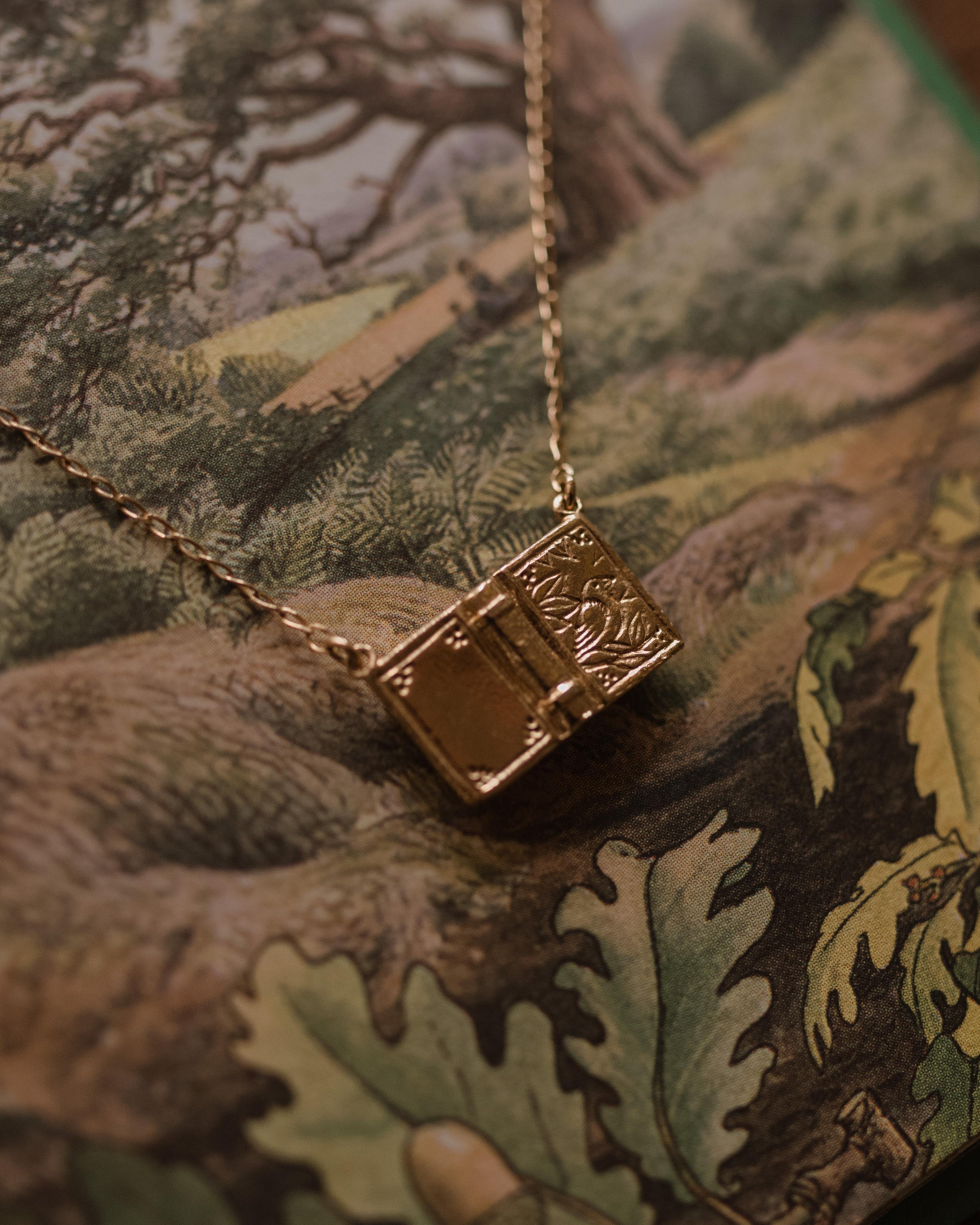 This highly detailed open book necklace is cast in solid 18 Carat gold and finished by hand, and is created from Lucy's original hand-sculpted design.  The necklace is approximately 17 inches in length. 

This book necklace is made in London, United