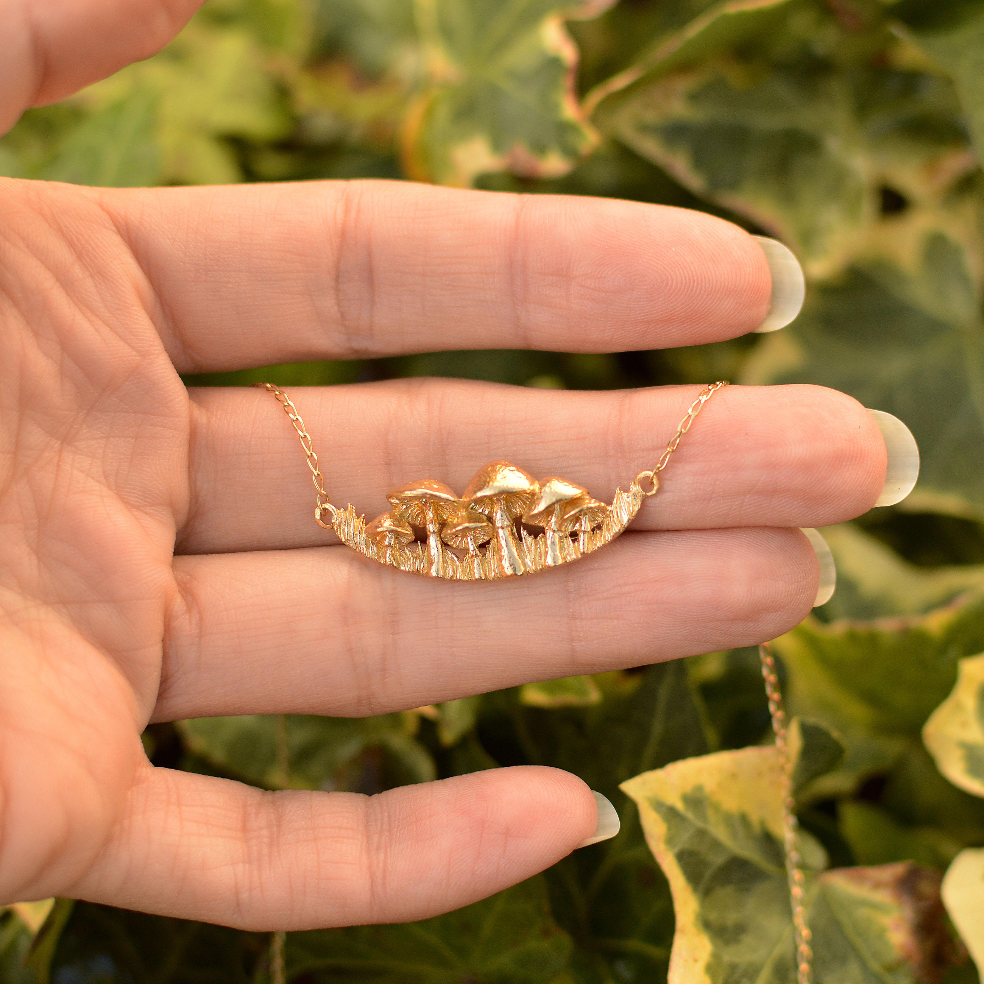 This magical mushroom patch necklace is cast in solid 18 Carat gold and finished by hand, and is created from Lucy's original hand-sculpted design.  The necklace is approximately 17 inches in length. 

This mushroom necklace is made in London,