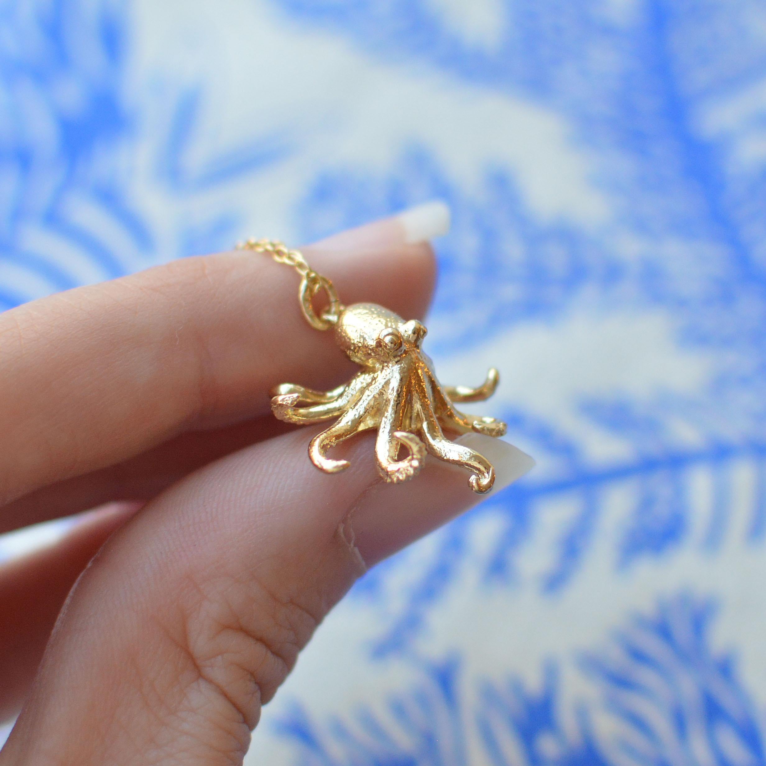 This detailed little octopus pendant is cast in solid 18 Carat gold and finished by hand, and is created from Lucy's original hand-sculpted design. 

This intricate octopus pendant is made in London, United Kingdom using recycled or Fairtrade Gold.