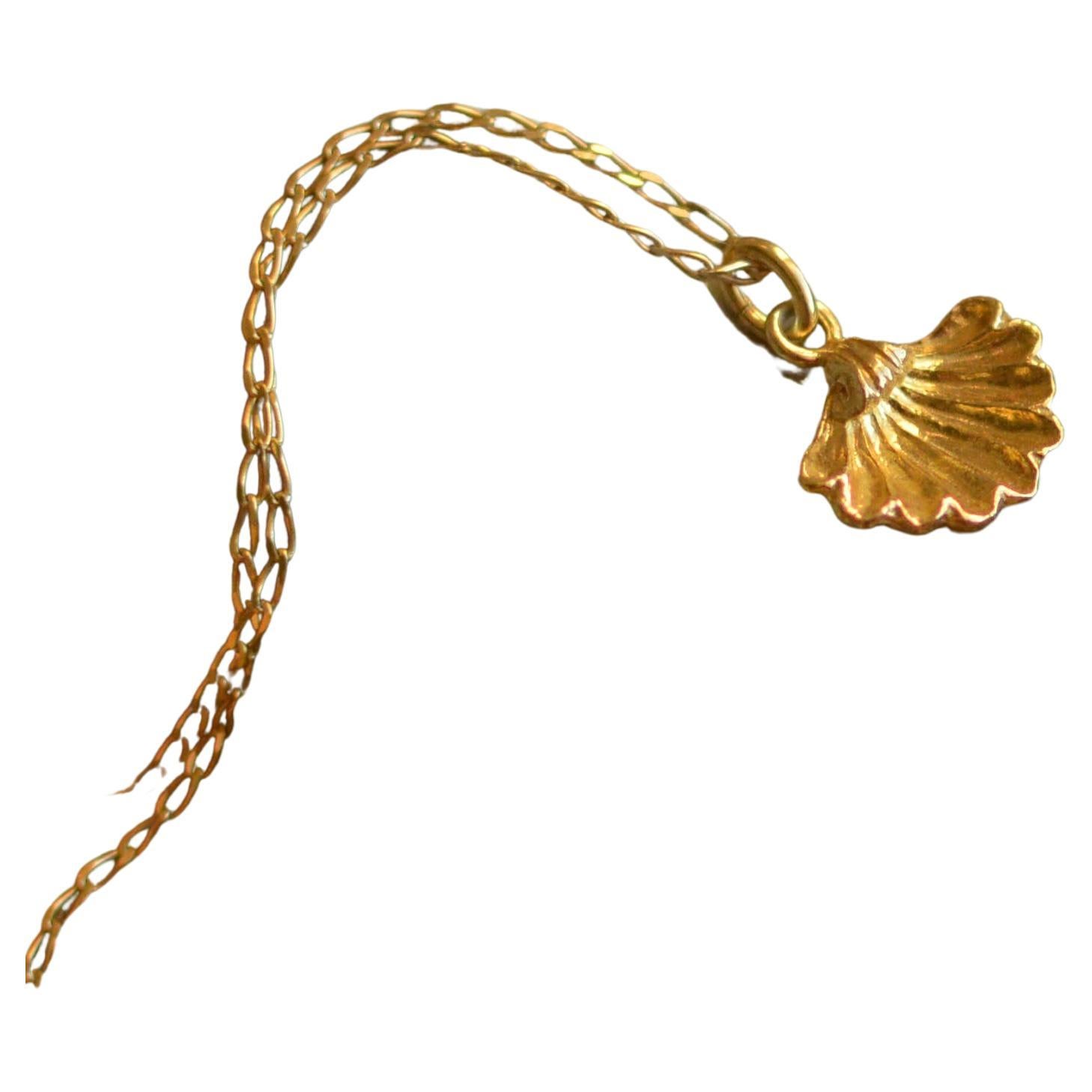 This tiny little shell pendant is cast in solid 18 Carat gold and finished by hand, and is created from Lucy's original hand-sculpted design. 

This beautiful scallop shell pendant is made in London, United Kingdom using recycled or Fairtrade Gold.