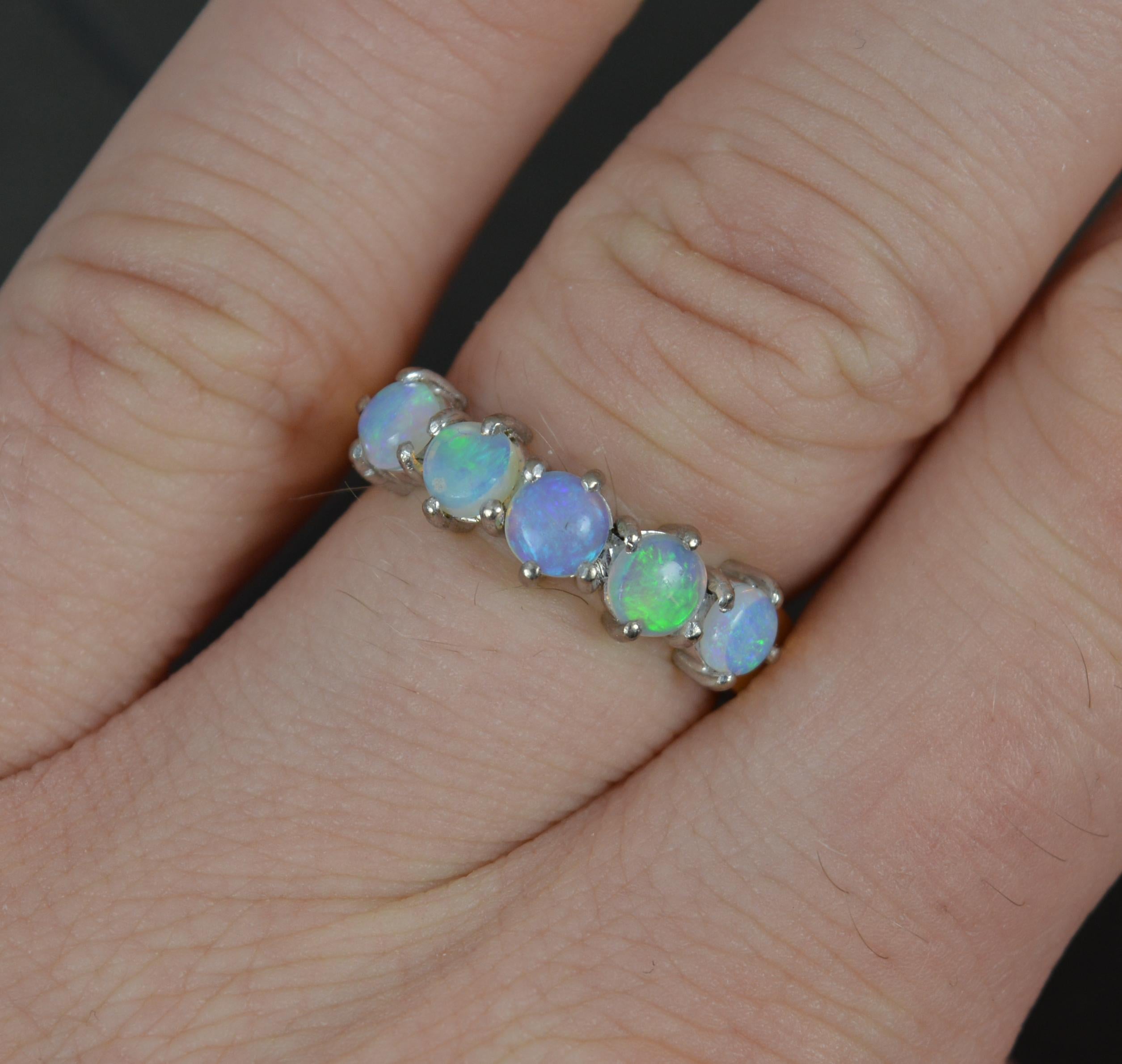 A superb five stone ring.
Solid and well made 18 carat gold example. Yellow gold shank and white gold claw setting.
Designed with five, natural, round cut opals, each full of colour. 
20mm spread of stones. 5mm wide. 
CONDITION ; Very good. Clean