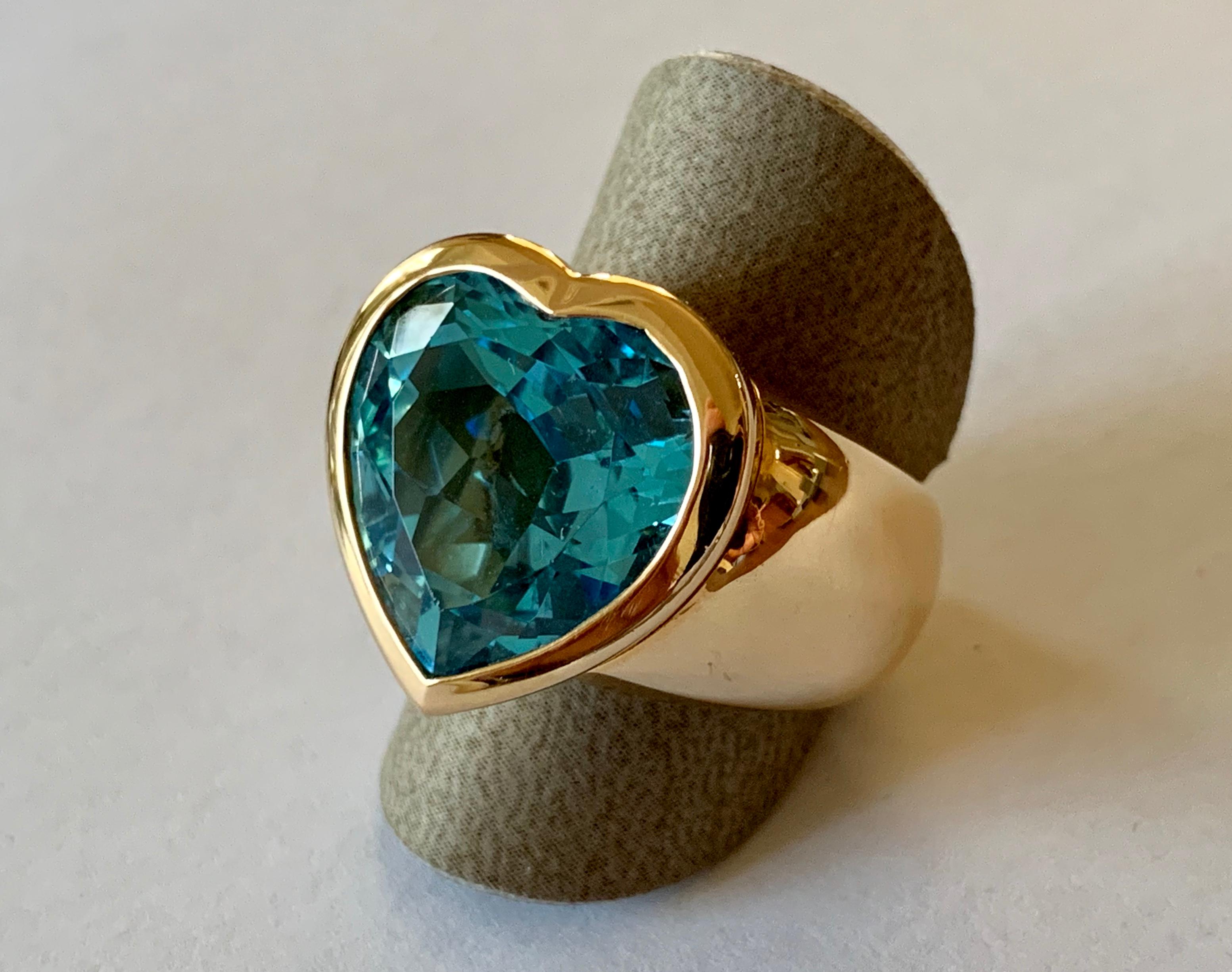 One of a kind solid 18 K rose Gold Ring set with a heart shaped blue Topaz.  This unique piece has been designed and handcrafted from the very well known swiss company 