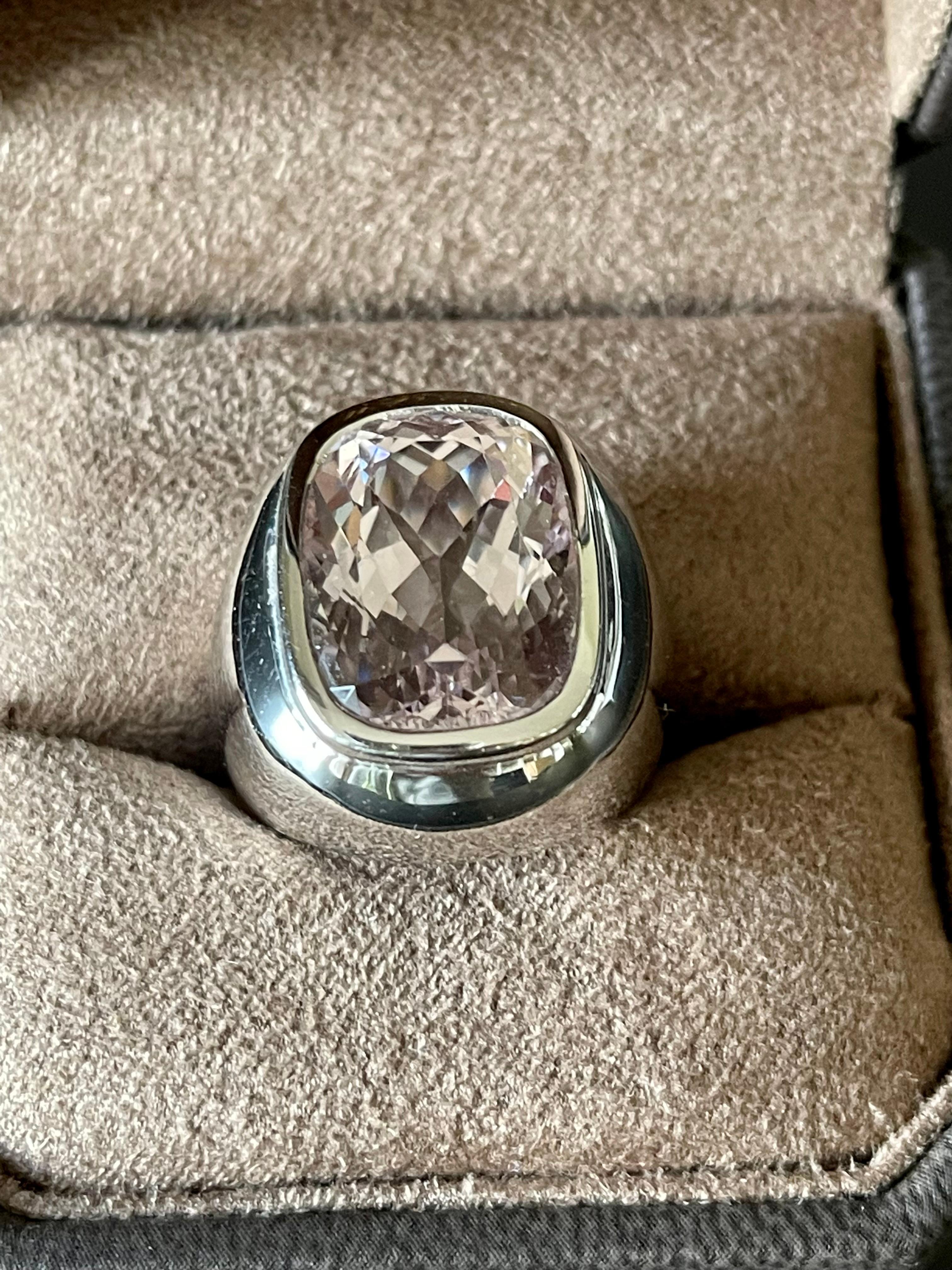 Solid 18 K white Gold Ring featuring a light pink colored bezel set cushion cut Kunzite wieghing 18.02 ct. 
The ring is currently size 55 ( US size 7 1/2) but can easily be resized. 
Masterfully handcrafted piece! Authenticity and money back is