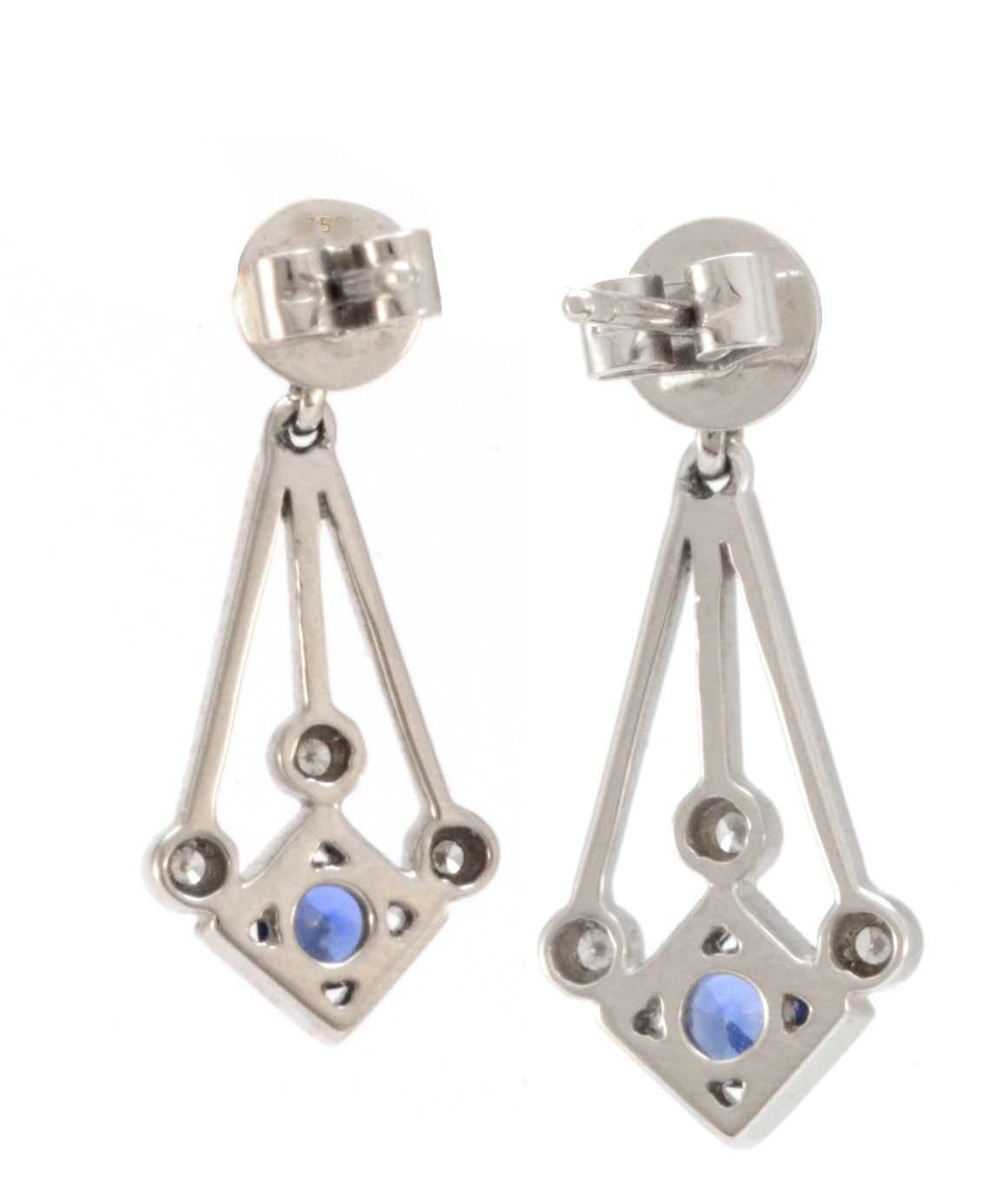 Solid 18K White Gold Sapphire & Diamond Dangle Earrings 3.3g Excellent condition. These solid 18k white gold earrings each feature a round genuine sapphire that measures approximately 3.56mm each. Each earring also contains 4 genuine diamonds. The