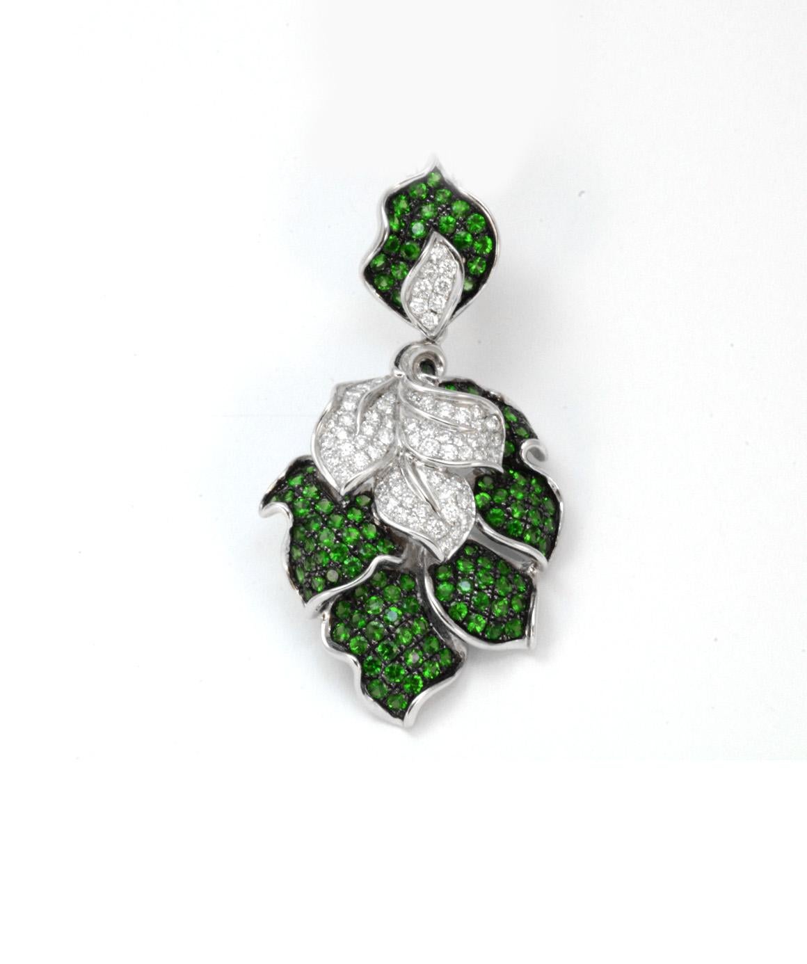 This solid 18K white gold Tsavorite Garnet & Genuine Diamond necklace is in excellent condition! The leaf style pendant measures 2.25 inches X 1.25 inches approximately. There are 117 genuine tsavorite garnets measuring approximately 2mm each. There