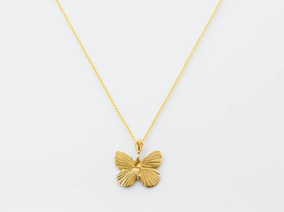 James Banks's signature butterfly necklace features a Baby Asterope butterfly with a hinge at the center to allow movement of the wings, set in 18k Yellow Gold and hung on a 17