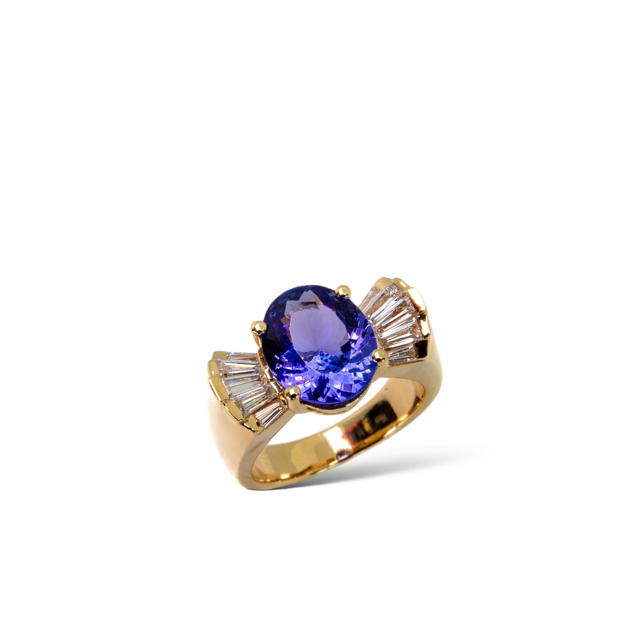 Our take on the 80s fine jewellery featuring a solid chunky gold ring setting. Beautiful Tanzanite and diamond cocktail ring in a heavy 18K Yellow Gold setting. 

The combination of purple-blue Tanzanite, colourless diamonds and yellow gold is