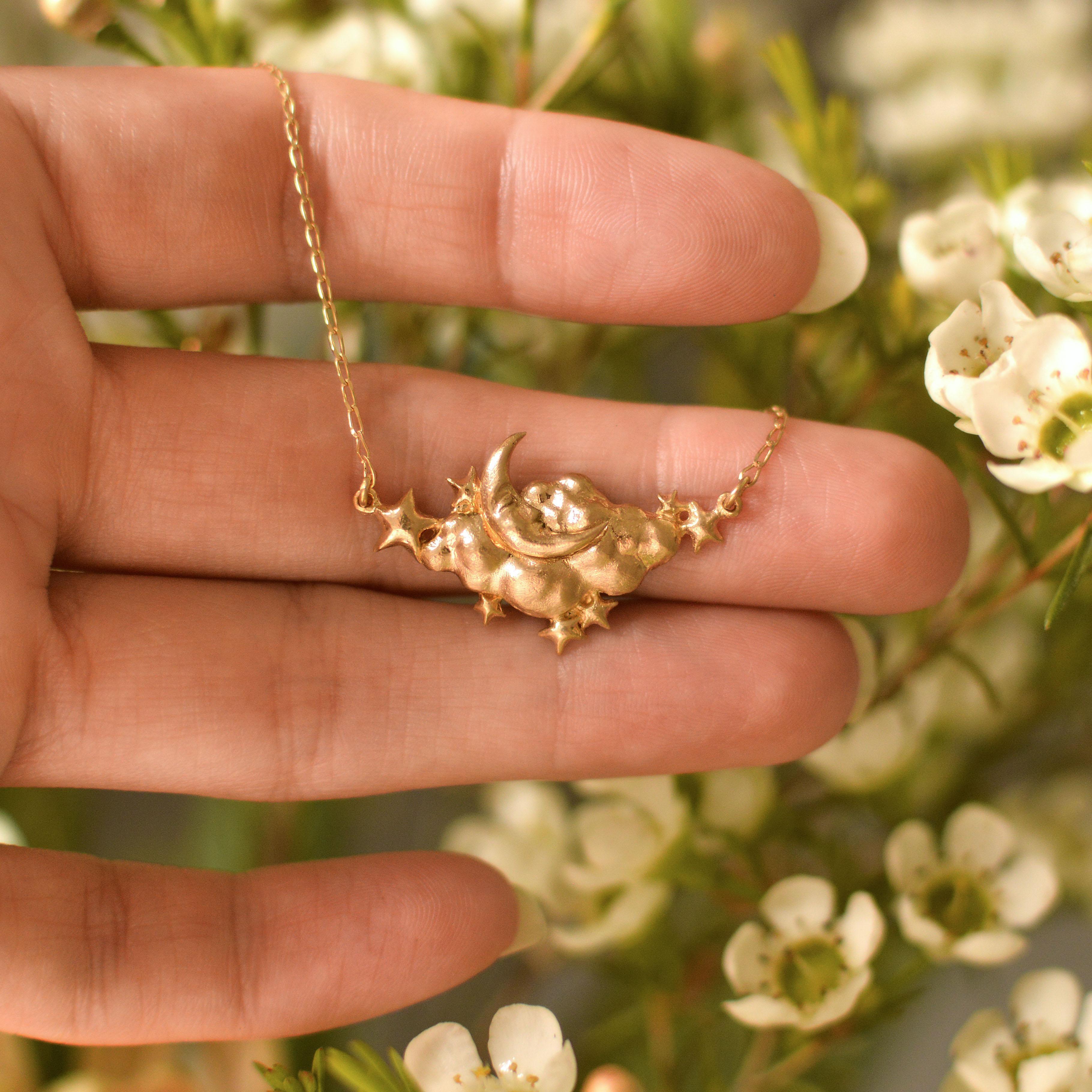 A beautiful dreamy man in the moon, cloud and stars necklace is cast in solid 18 Carat gold and finished by hand, and is created from Lucy's original hand-sculpted design. 

This necklace is made in London, United Kingdom using recycled or fairtrade