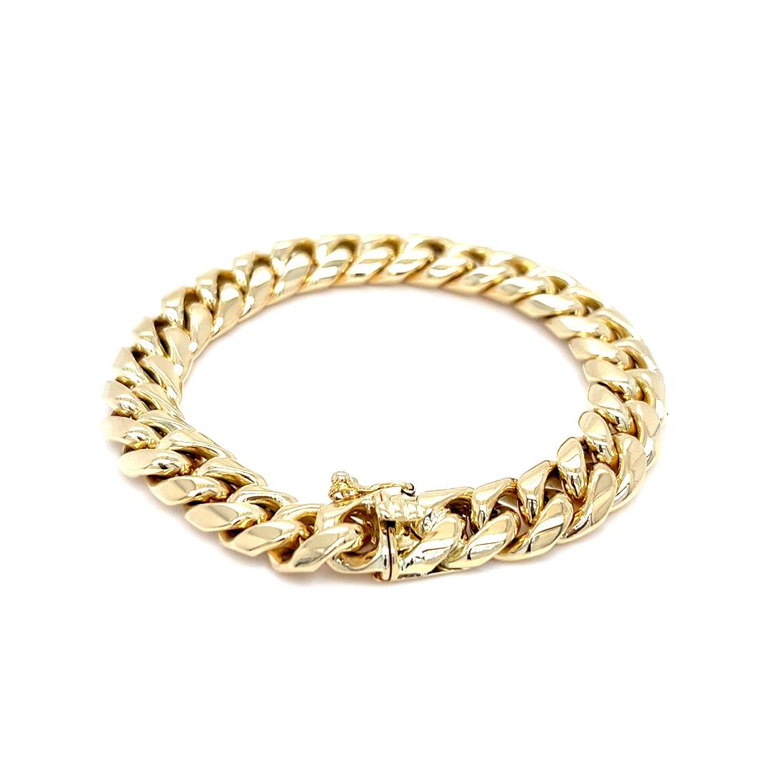 This bold and timeless Cuban link bracelet is crafted in solid 18 karat yellow gold and features a classic 10mm width, offering substantial presence and luxurious weight. Measuring 7 inches in length, the bracelet is secured with a hidden box clasp