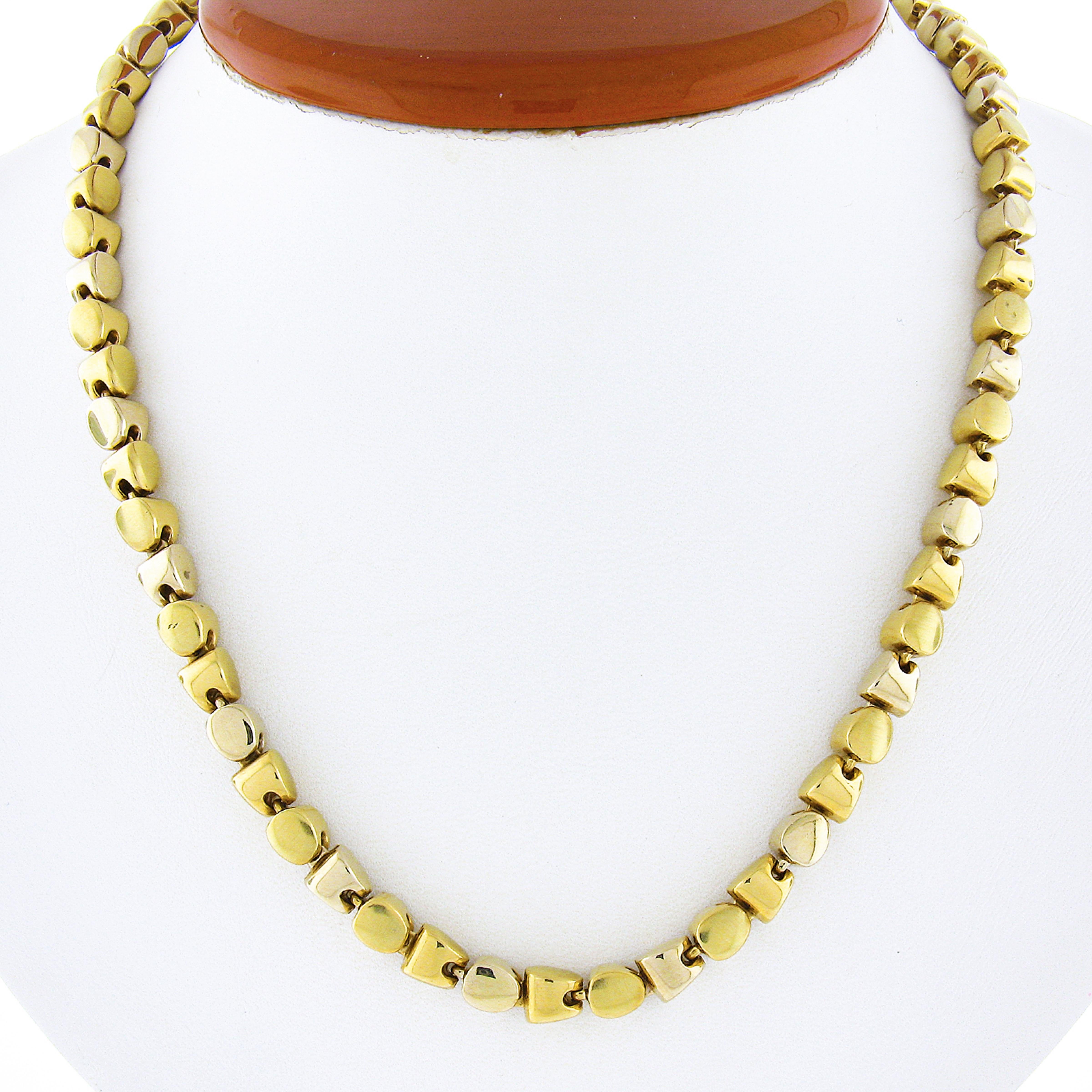 Here we have a unique chain necklace that was crafted from solid 18k yellow gold. The necklace features simple and elegant geometric links giving this piece its unique look. The links alternate with a high polished finish and a wonderful brushed