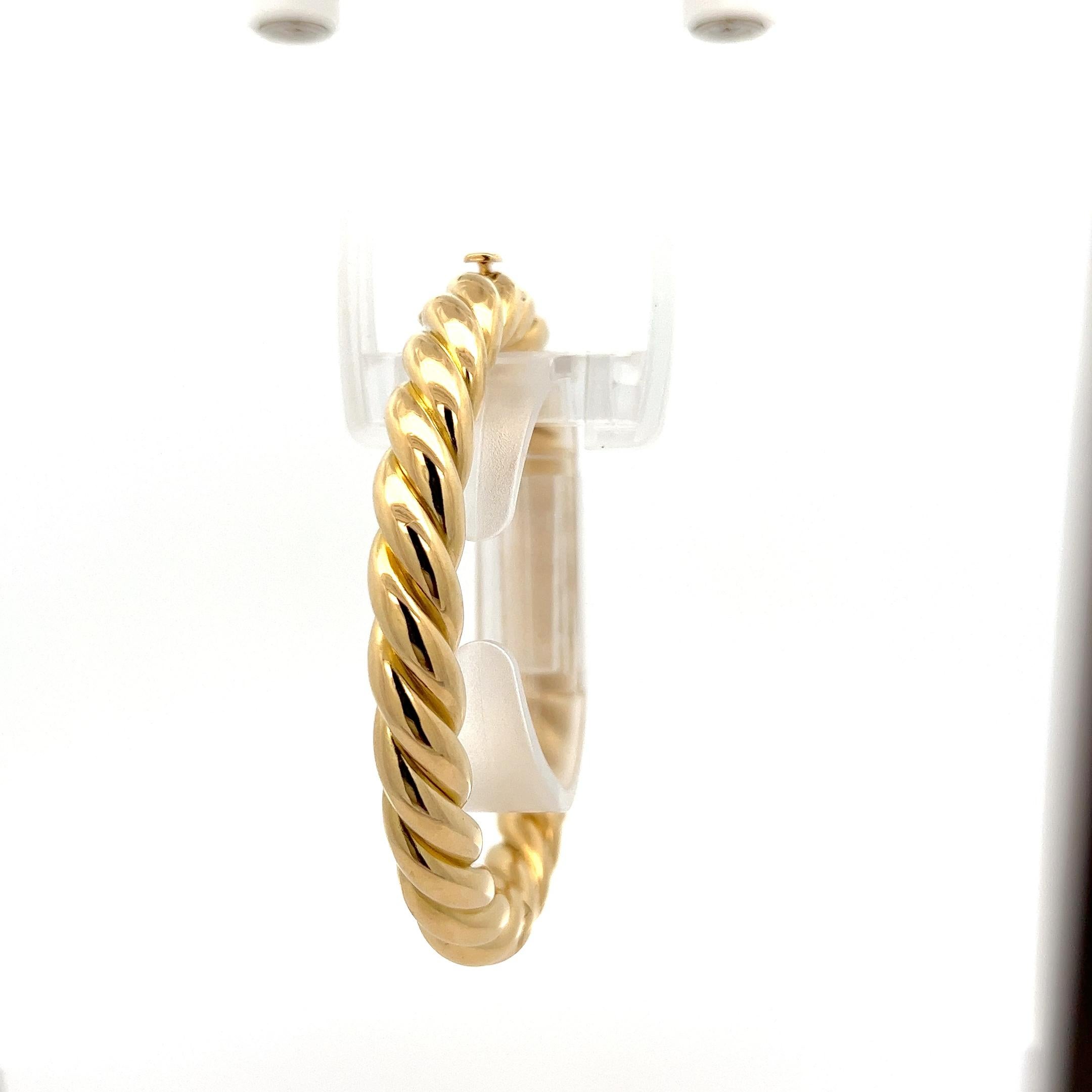 Material: Solid 18K Yellow Gold
Weight: 40.11 Grams
Type: Puffed Cable Hinged Open Bangle Bracelet
Length: Will fit up to a 7 inch wrist (Fitted on a wrist)
Clasp: Push Clasp w/ Safety Latch
Width: 8.6mm 
Thickness: 8.7mm rise off the wrist