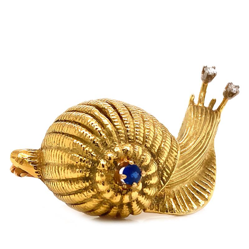 Solid 18K Yellow Gold Diamond and Sapphire Snail Pin/ Brooch 13.7g This cute brooch has two diamonds, approximately 0.06cttw, G-H color, SI1 clarity. As well as a round sapphire, measuring about 2.9mm. This brooch measures about 1.50