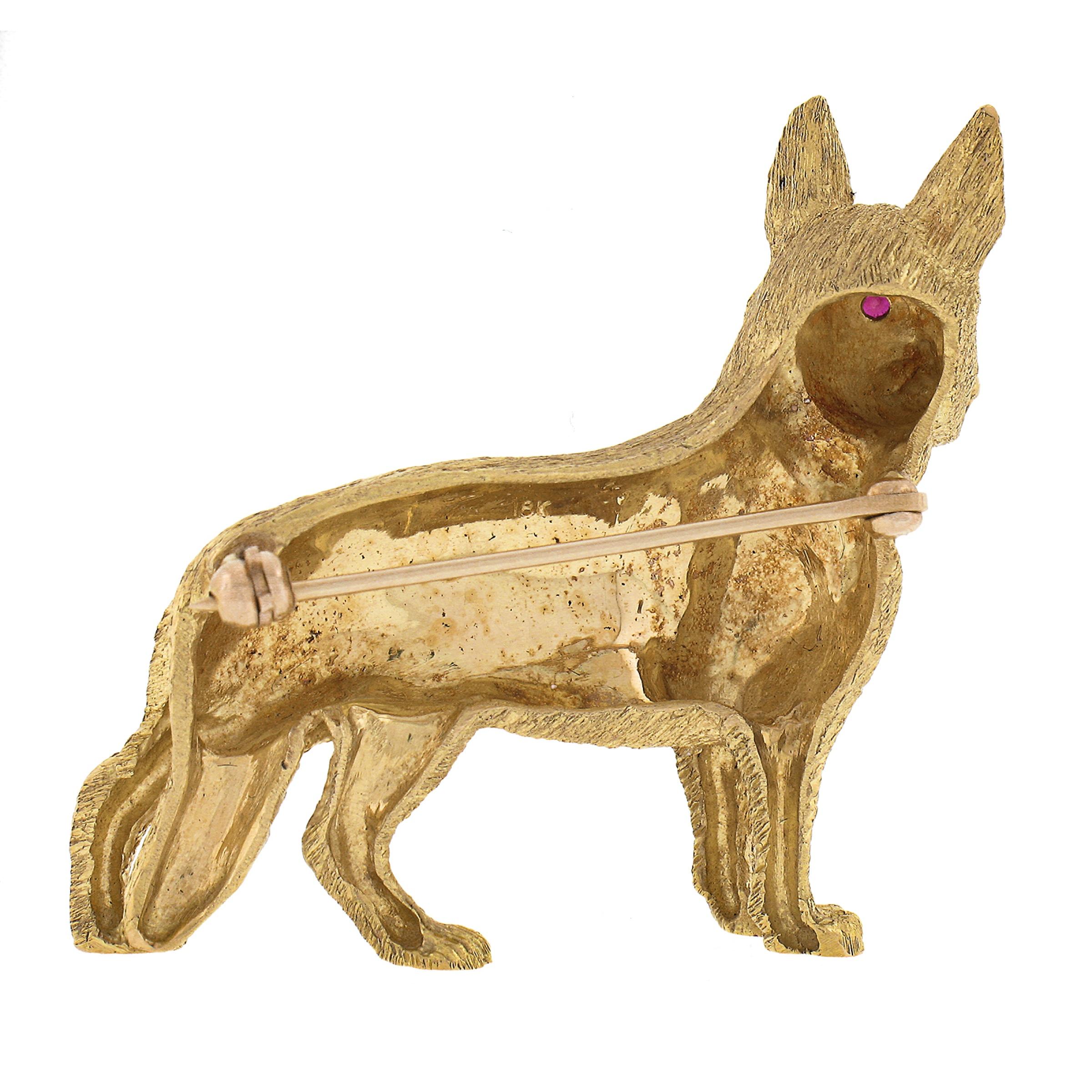 This incredible well detailed pin brooch is solidly crafted in 18k yellow gold and features a perfectly structured standing German Shepherd dog design set with fine red rubies at its eyes. An absolutely beautiful piece of that is sure to impress and