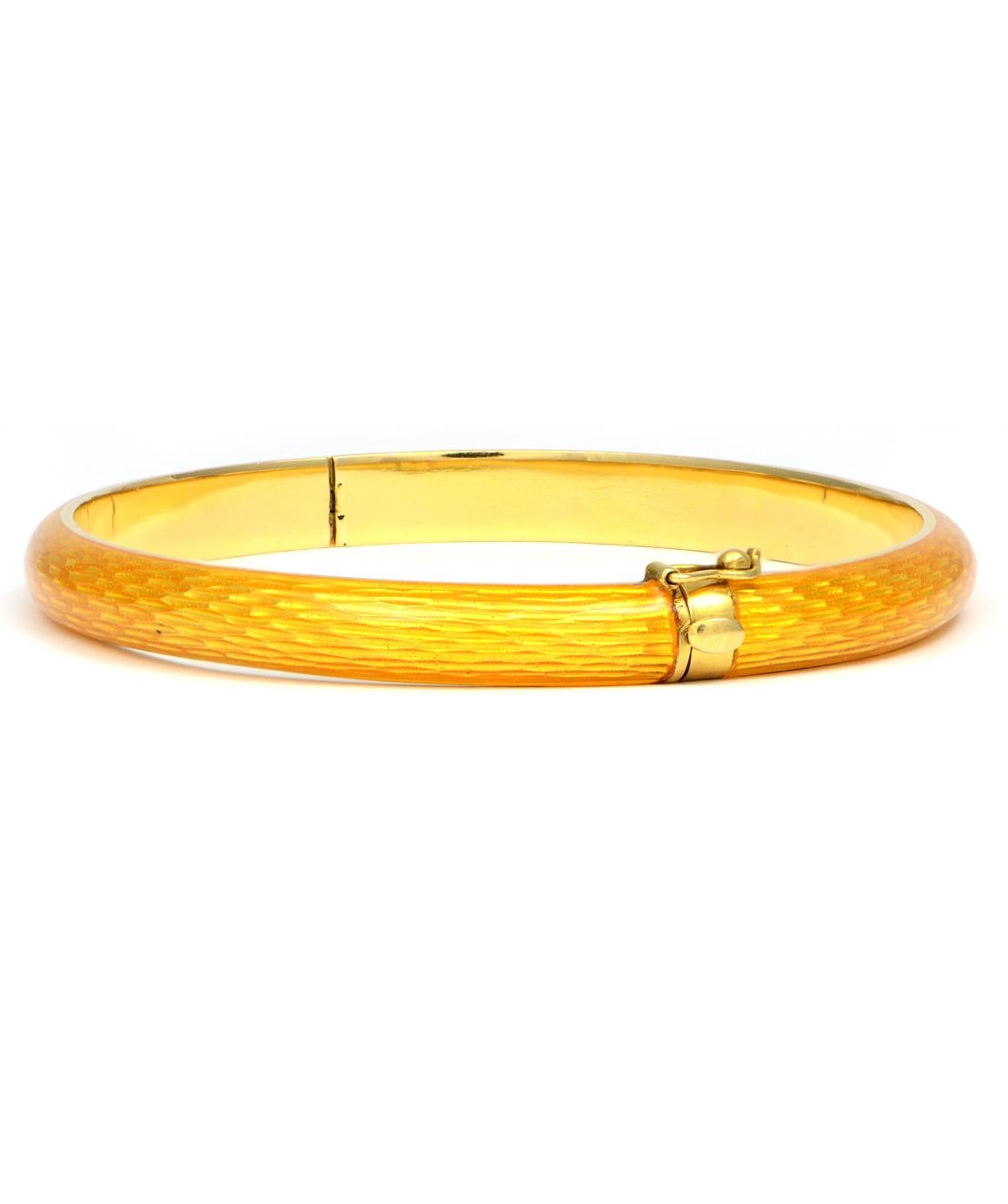 Excellent condition. This solid 18k yellow gold bangle bracelet features yellow enamel. The enamel is in excellent condition, I do not see any chips. The bangle has a bamboo style to it. The inside dimensions measure approximately 2.20 inches wide X